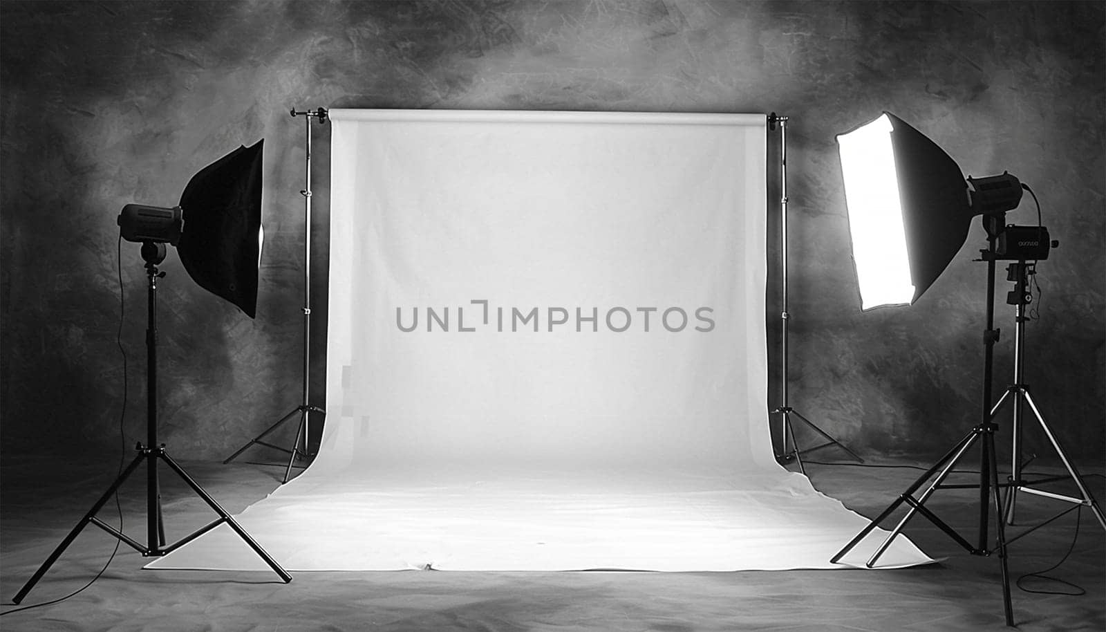Commercial photo studio. Photo session studio. Photographer's workplace in commercial atelier agency. Sunny workspace interior with grey backdrop, backstage and lamp, umbrella, flashlight illumination equipment kit. No people