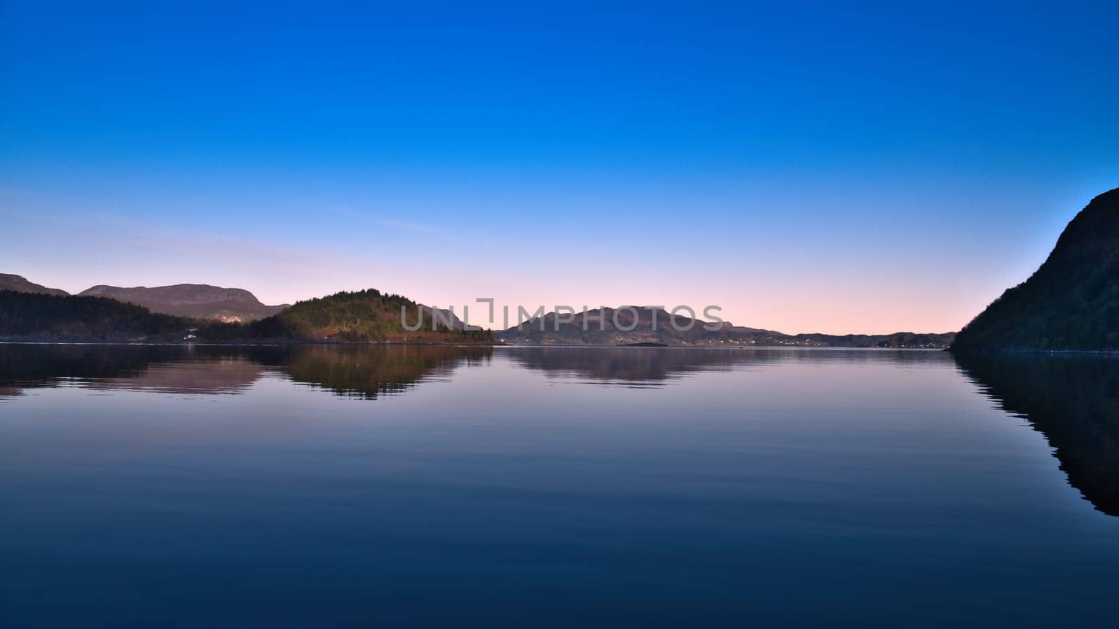 Fjord with view of mountains and fjord landscape in Norway. Landscape shot in the evening in the north at sunset
