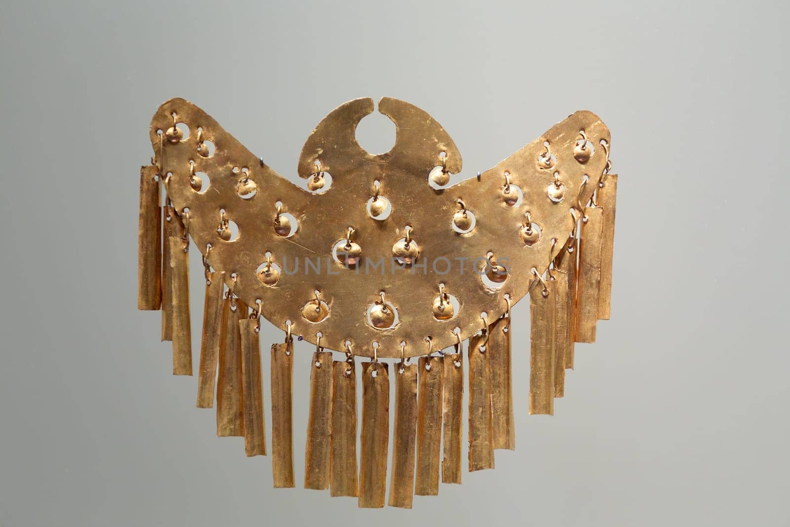 Pre-Columbian gold statuette in the Museo del Oro. Golden indigenous ornament from South American natives civilization. Famous Gold Museum, Bogota, Colombia.