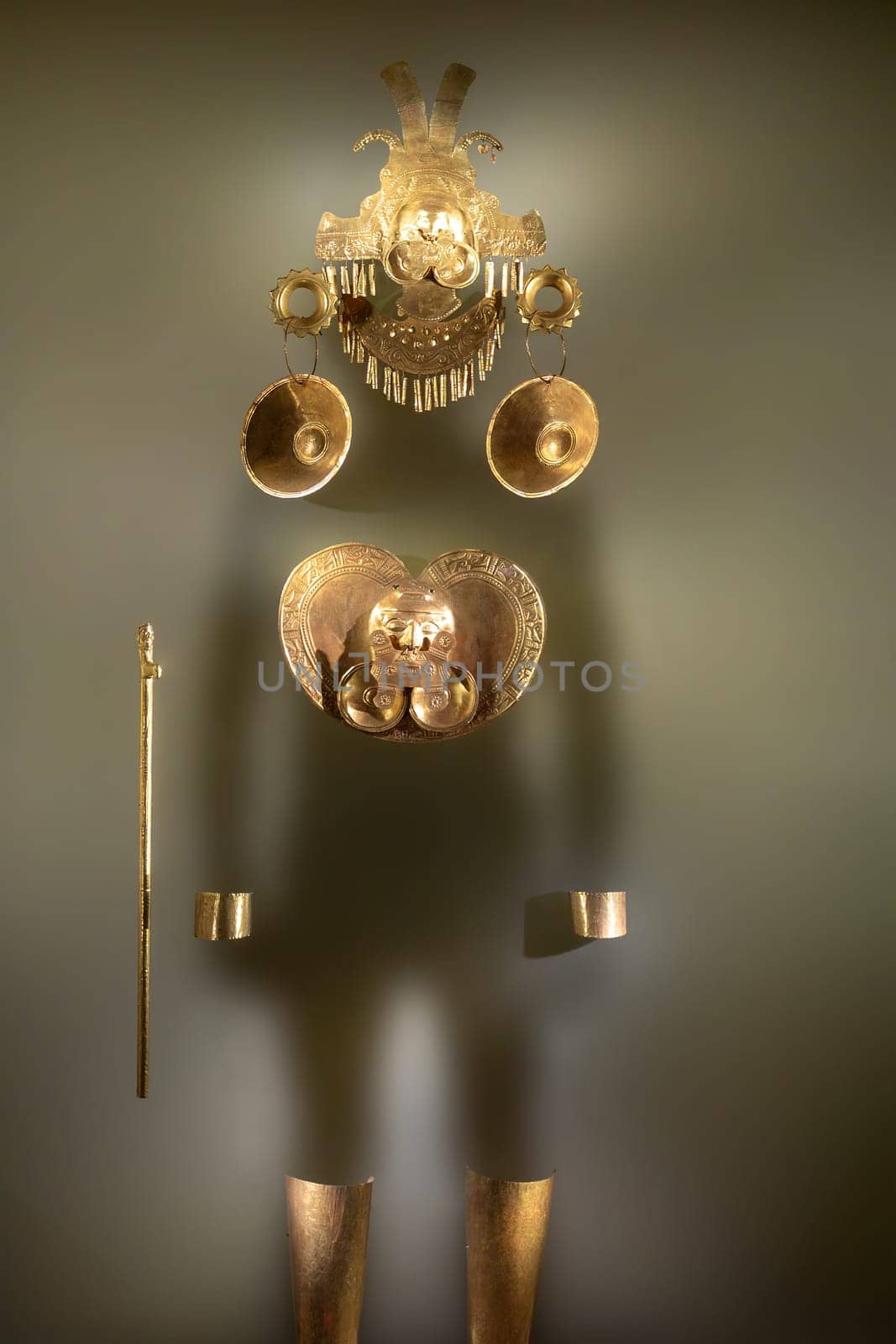 Pre-Columbian gold statuette in the Museo del Oro. Golden indigenous ornament from South American natives civilization. Famous Gold Museum, Bogota, Colombia.