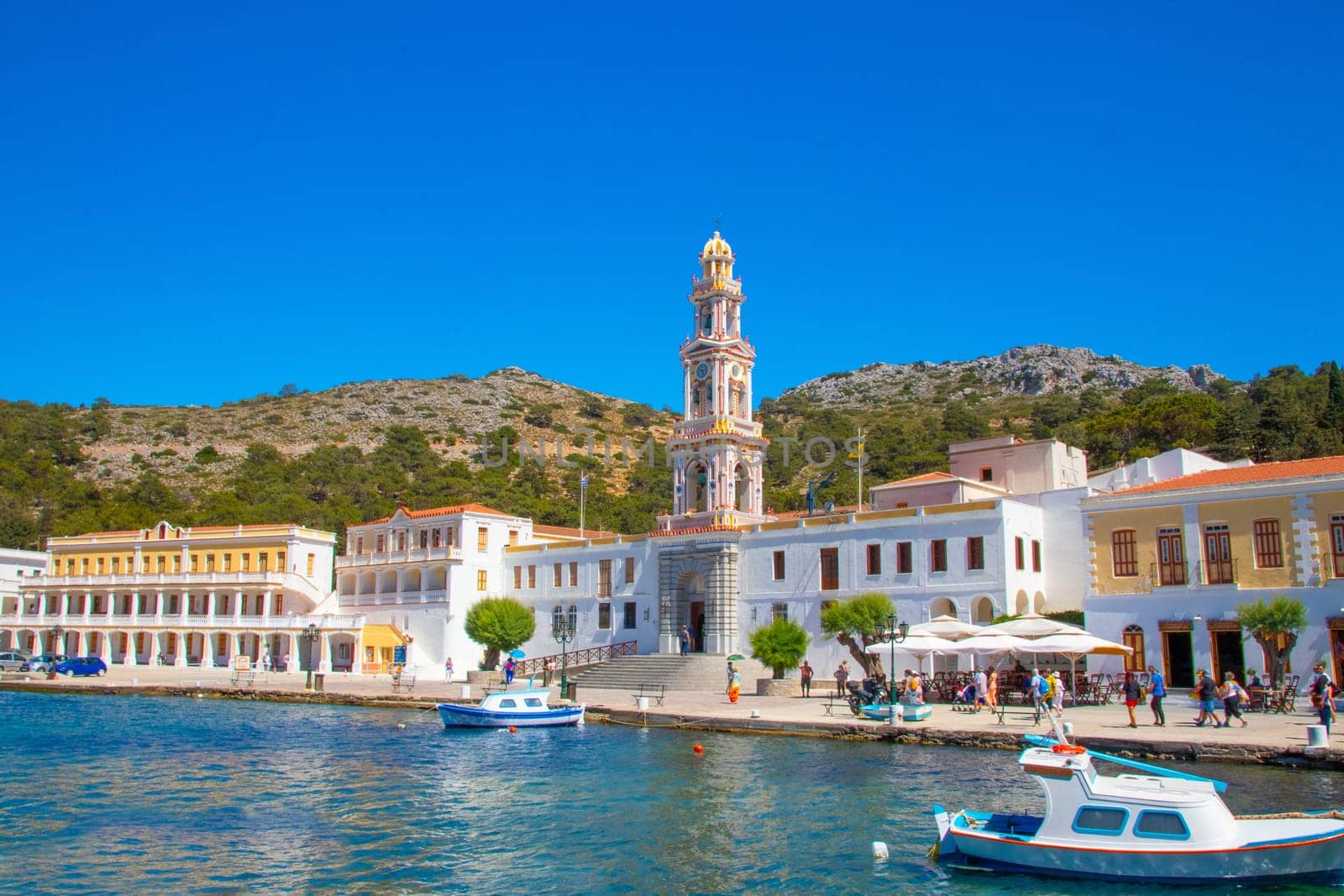SYMI, Greece - JUN 03, 2021. SYMI, Greece - JUN 03, 2021. Panormitis Monastery of Archangel Michael in the southwest of the island of Symi is an important orthodox pilgrimage site and an important tourist attraction.