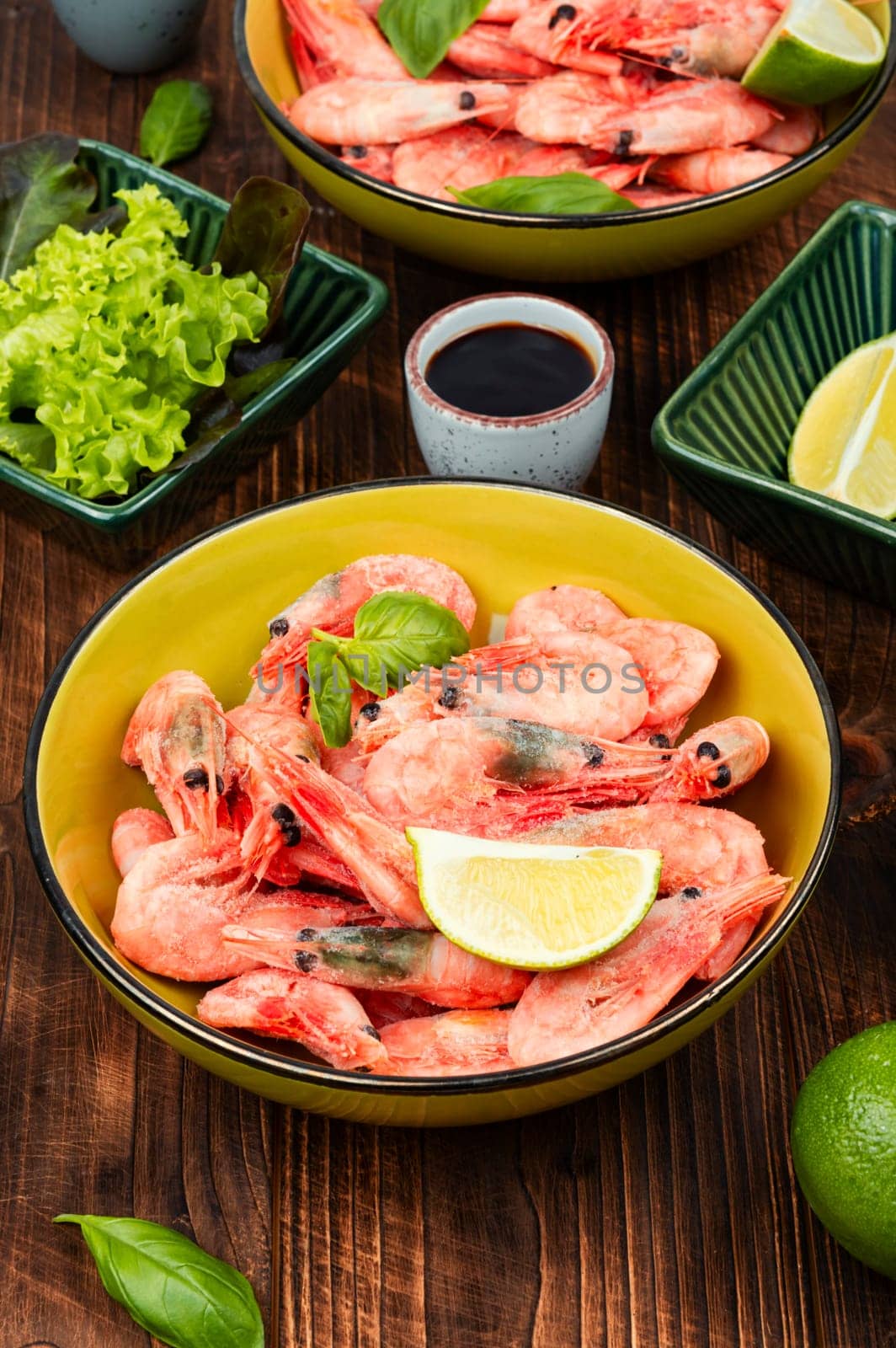 Fresh raw shrimps or prawns in bowl. Space for text.