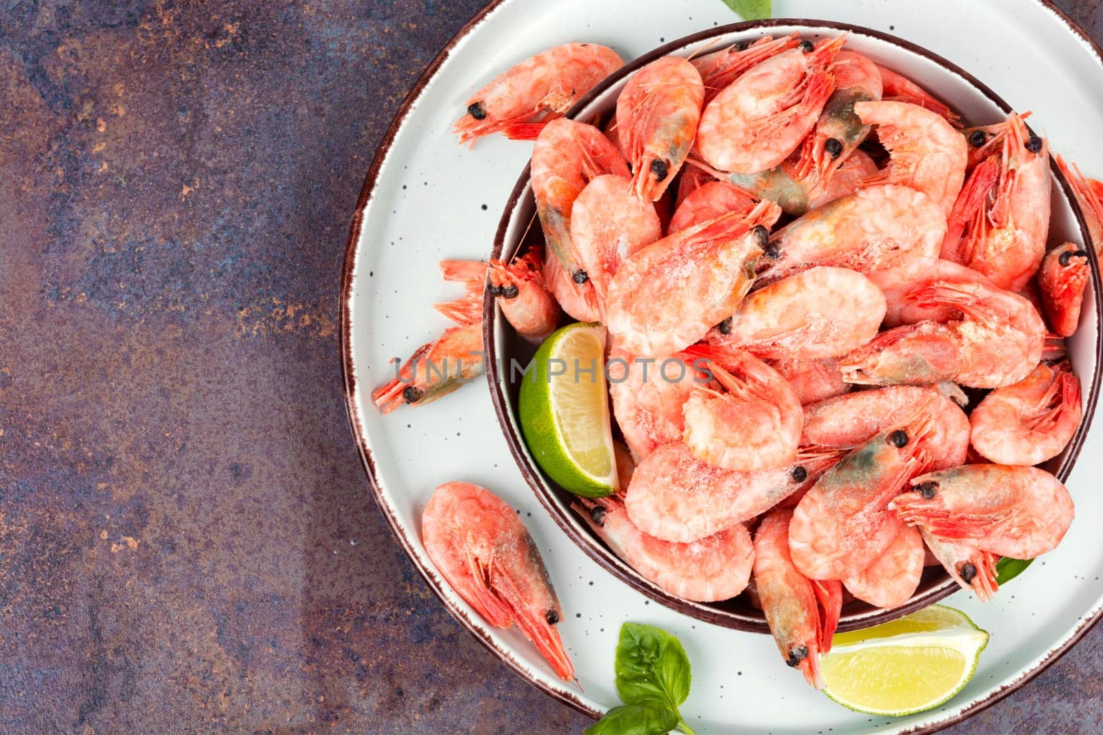 Fresh raw shrimps or prawns in bowl. Space for text.