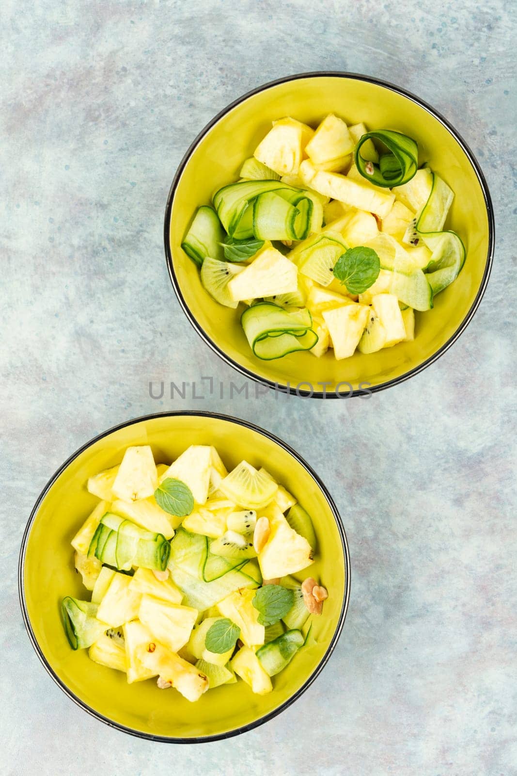 Tasty vegetarian appetizing salad pineapple, cucumber and nuts salad. Space for text.