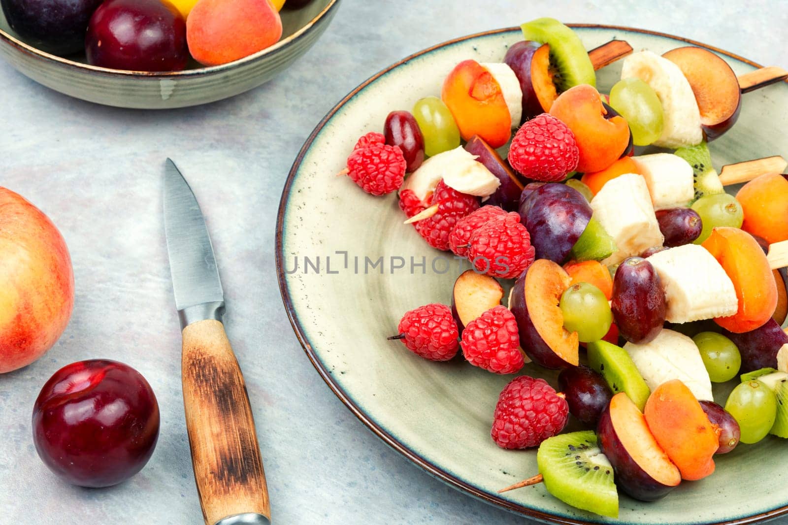 Juicy fruit skewers made from fresh fruits on wooden skewers.