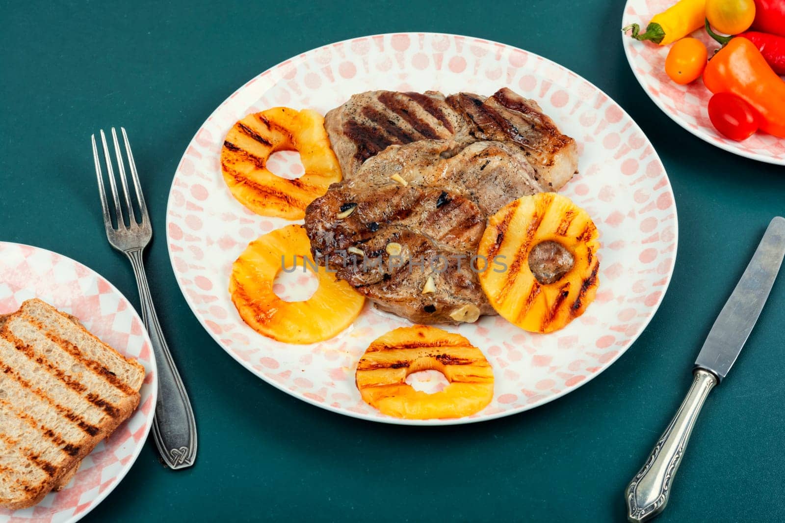 Tasty grilled meat,roasted with pineapple. Grilled steak and ananas on wooden table.