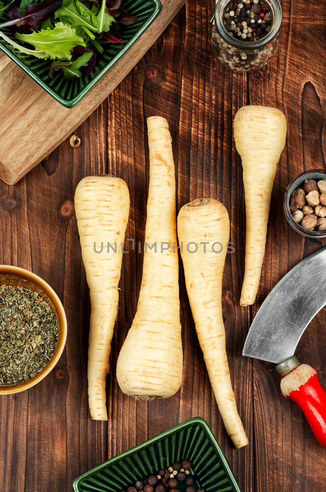 Uncooked parsnips roots on the kitchen table. Fresh vegetable. Top view.