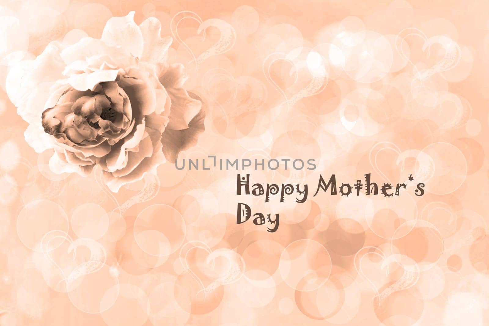 Happy Mothers Day Card. A champagne brown greeting card with an artificial rose flower and the text on an abstract bright blurred heart background.