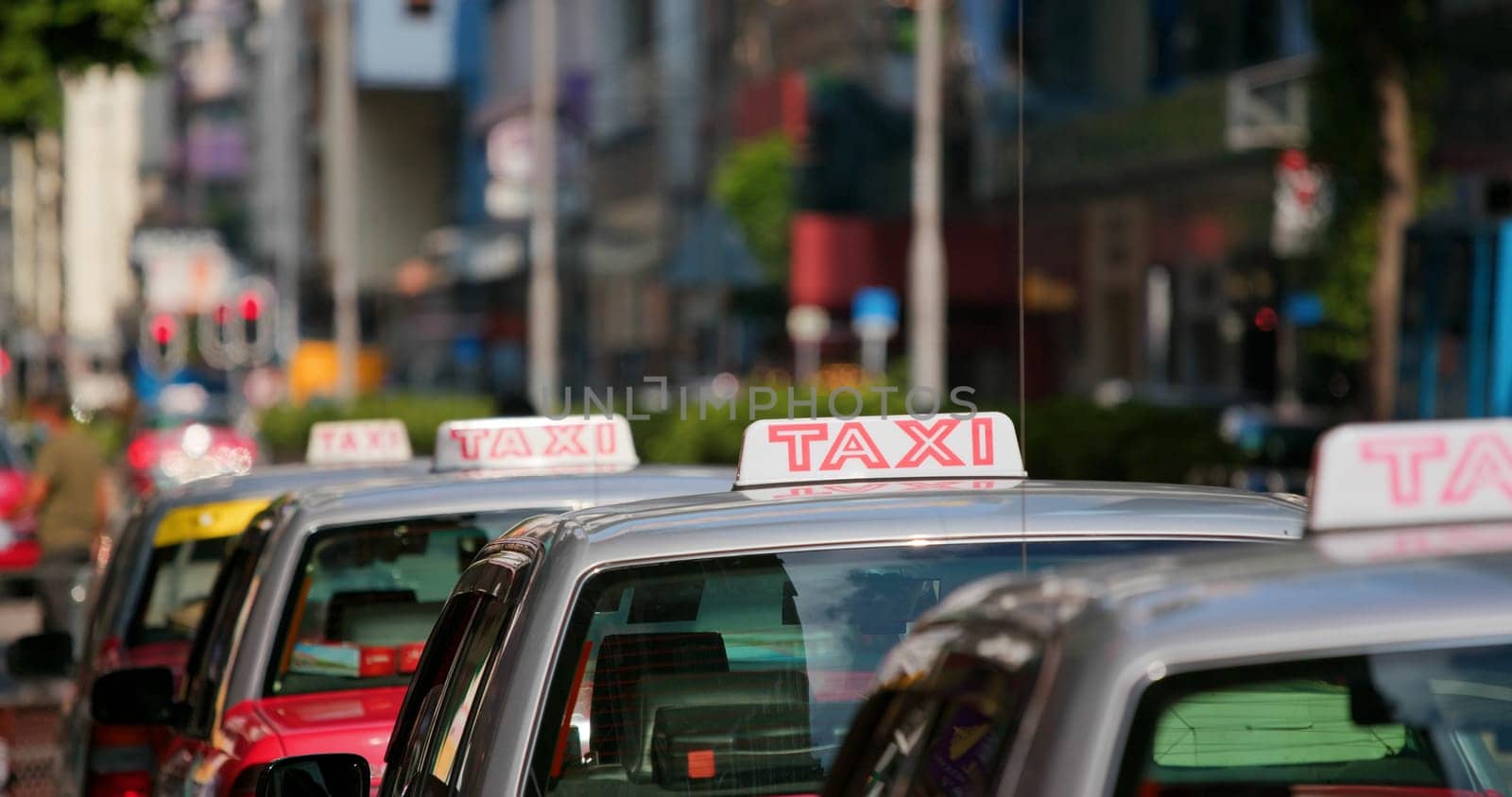 Taxi Sign in red color, moving in city