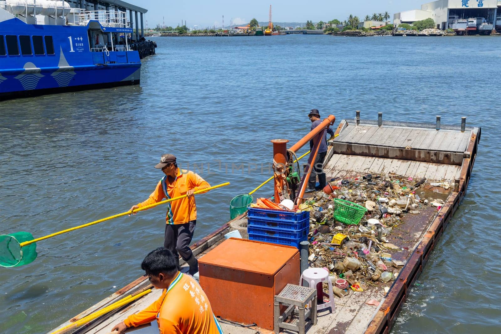 Taiwan 25 August 2022: Collect the trash on the ship over the sea