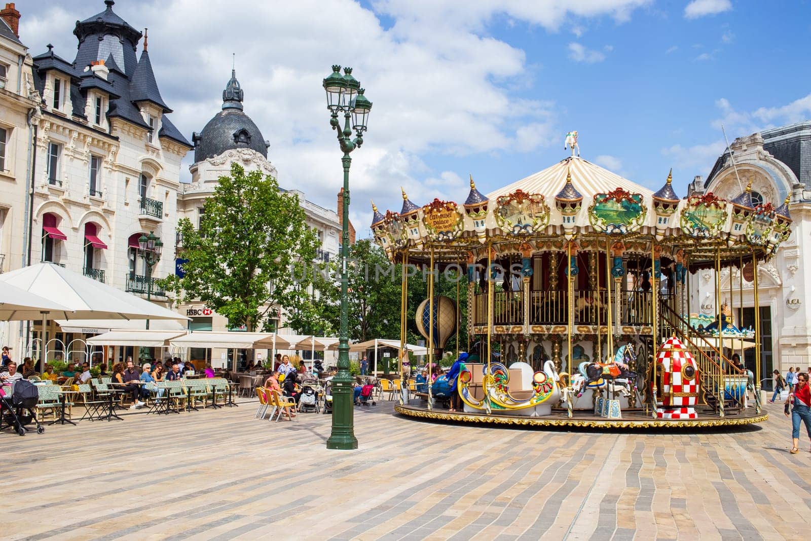 Orléans, France - July 20 2017: Carousel and people on the Place du Martroi in the city center of Orléans in the department of Loiret, Centre-Val de Loire, France