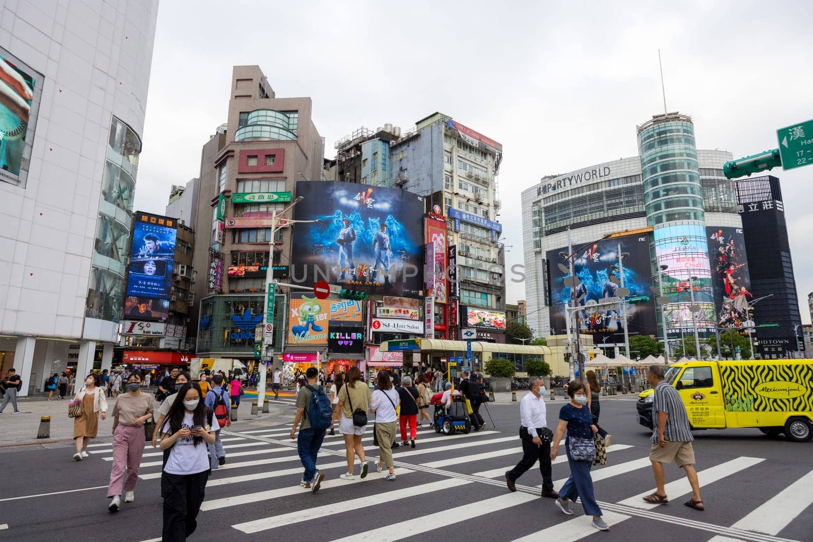 Taipei, Taiwan 13 September 2023: People cross the road in Taipei city street in Ximending