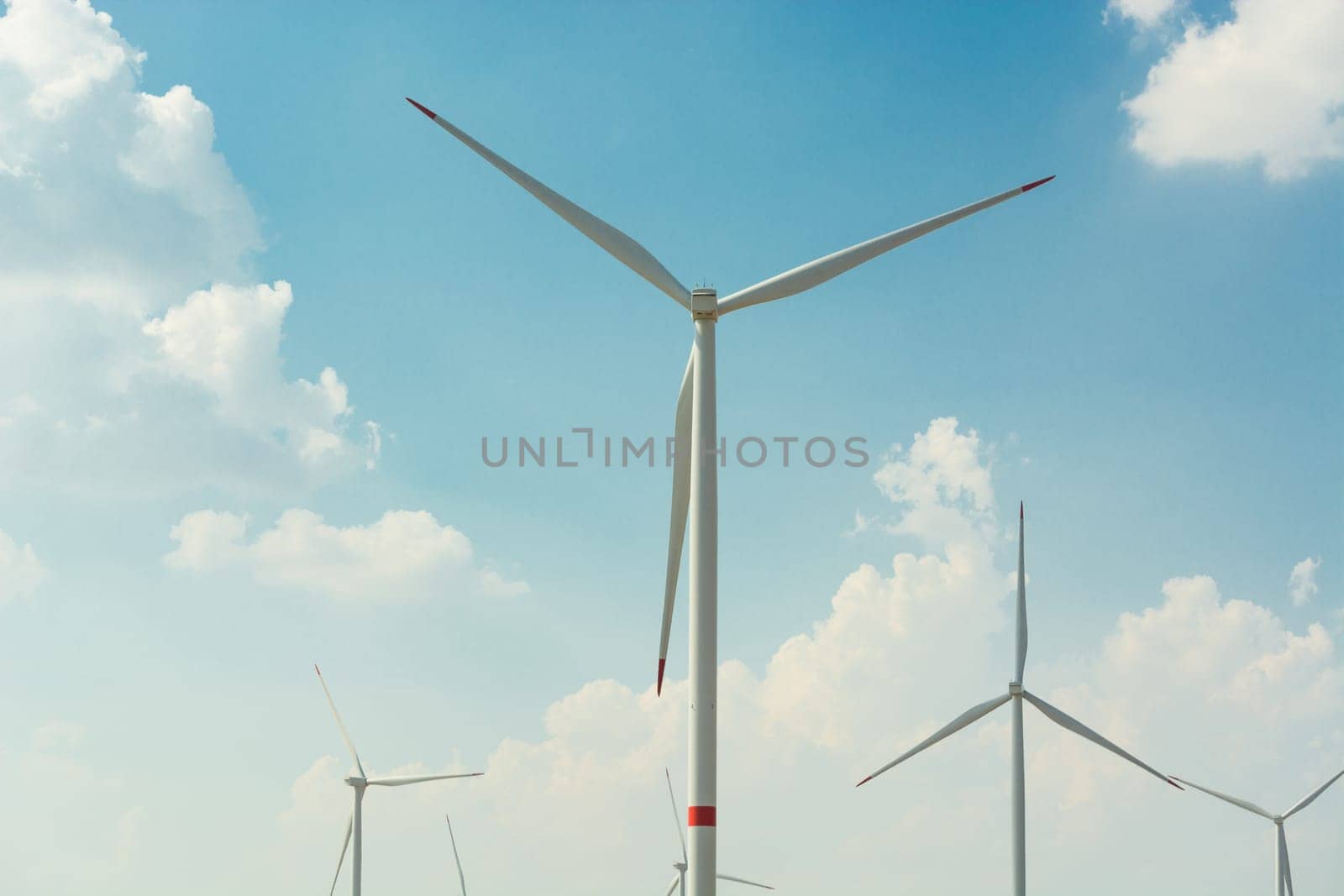 Sustainable green energy. Electric windmill generators in the sunrise