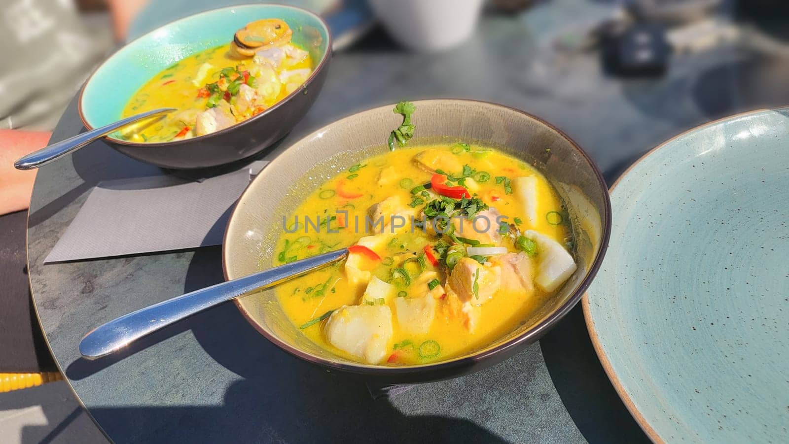 Traditional French Corsican fish soup with mussels and garlic baguette as a top view in a saucepan