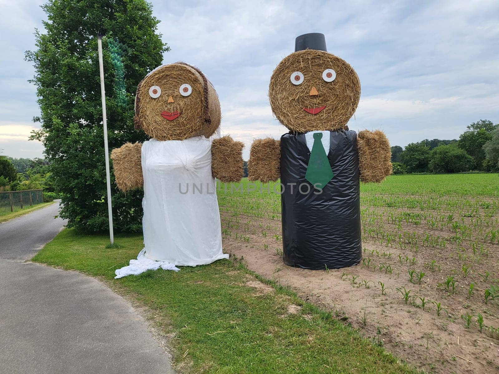 Scarecrow straw figures farmers and farmer's wife