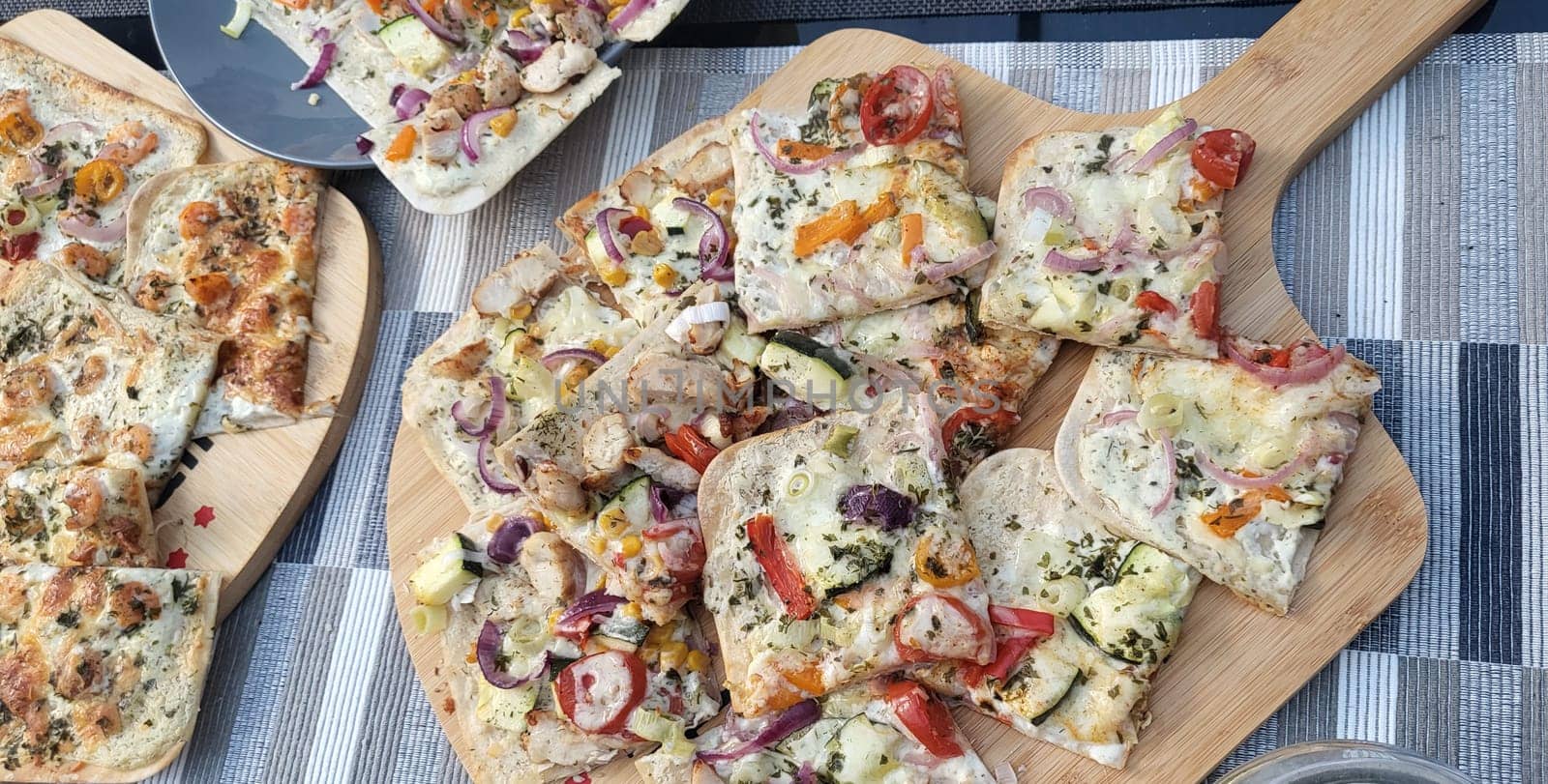 French tarte flambee with cream cheese, bacon and onions. Flammkuchen from Alsace region. Dark background. Top view