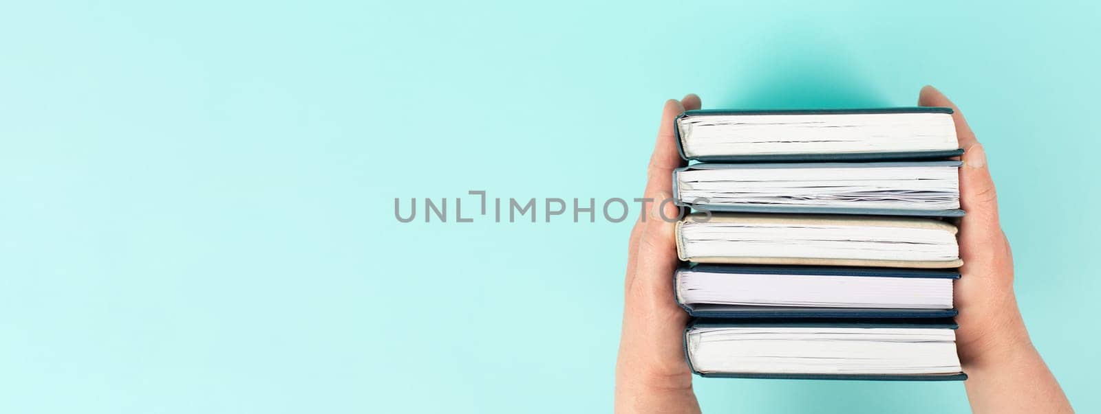 Hands holding pile of books, reading and learning new skill, knowledge is power, education concept, university student, back to school