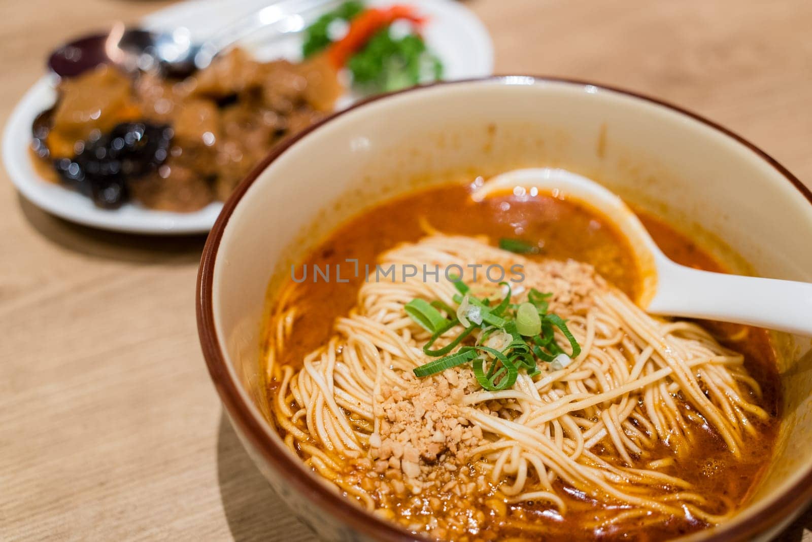 Shanghai spicy noodles soup bowl in restaurant