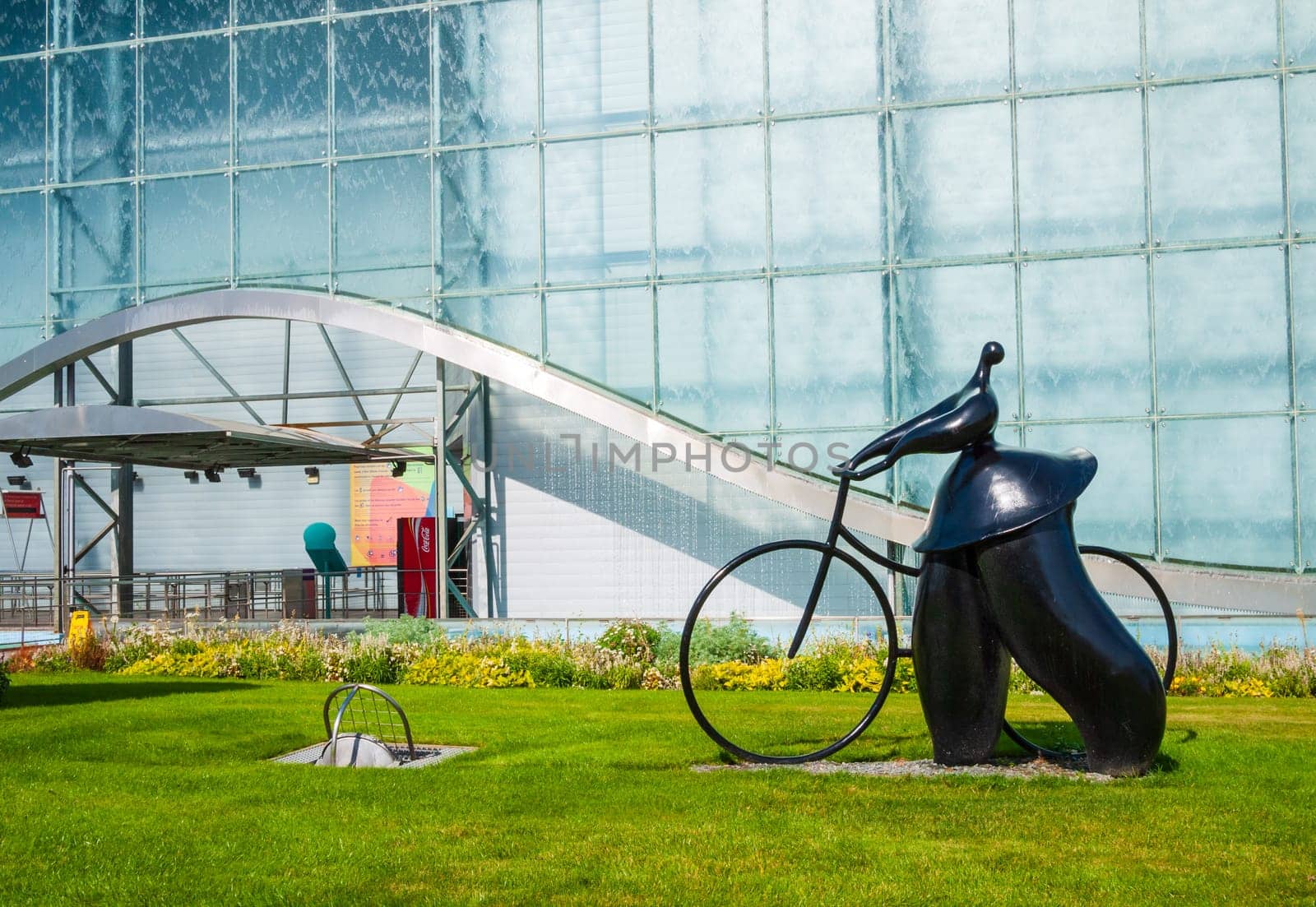 Poitiers, France - September 18 2010 : Pavillon de la Vienne, dynamic movie theatre, sculpture of cyclist from Jean-Louis Toutain in Futuroscope theme park in Poitiers, France
