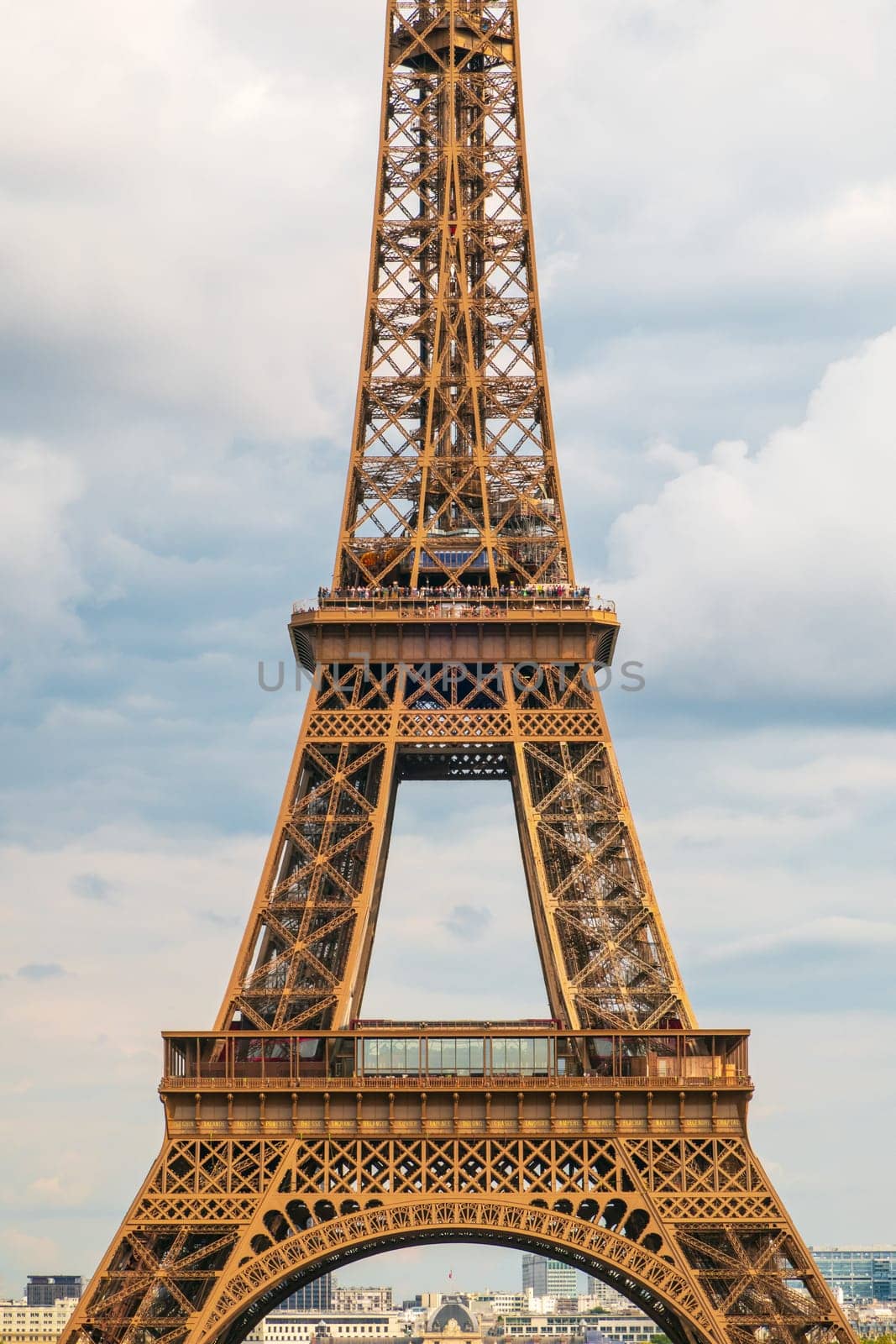 Paris, France - August 29 2023: The Eiffel tower seen from Trocadero in a cloudy day. Vertical photography taken in Paris