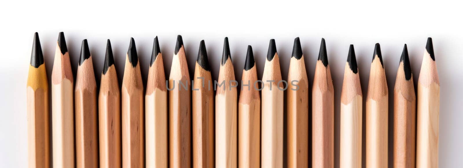 Neat arrangement of wooden pencils on a white background, with plenty of copy space.