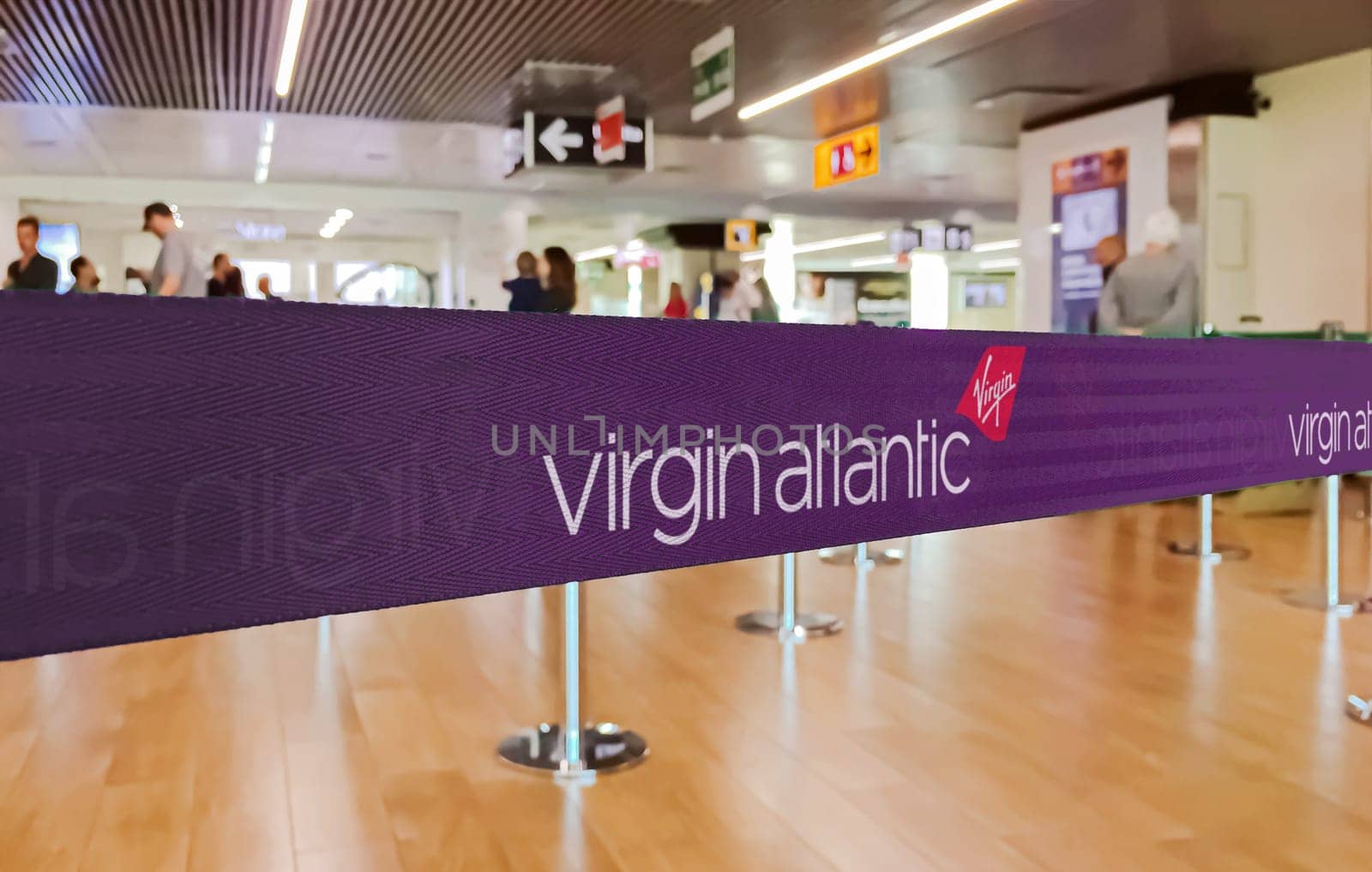 London, UK, May 14 2024  Close view of a Virgin Atlantic branded ribbon at a check-in counter, highlighting the airline’s distinctive purple branding and logo.