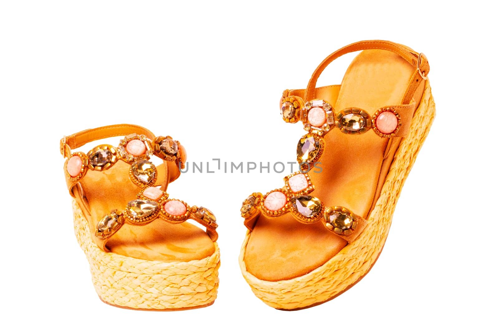Leather shoes isolated. Close-up of a pair of elegant female suede sandals with rhinestones. Isolated on white background. Macro.