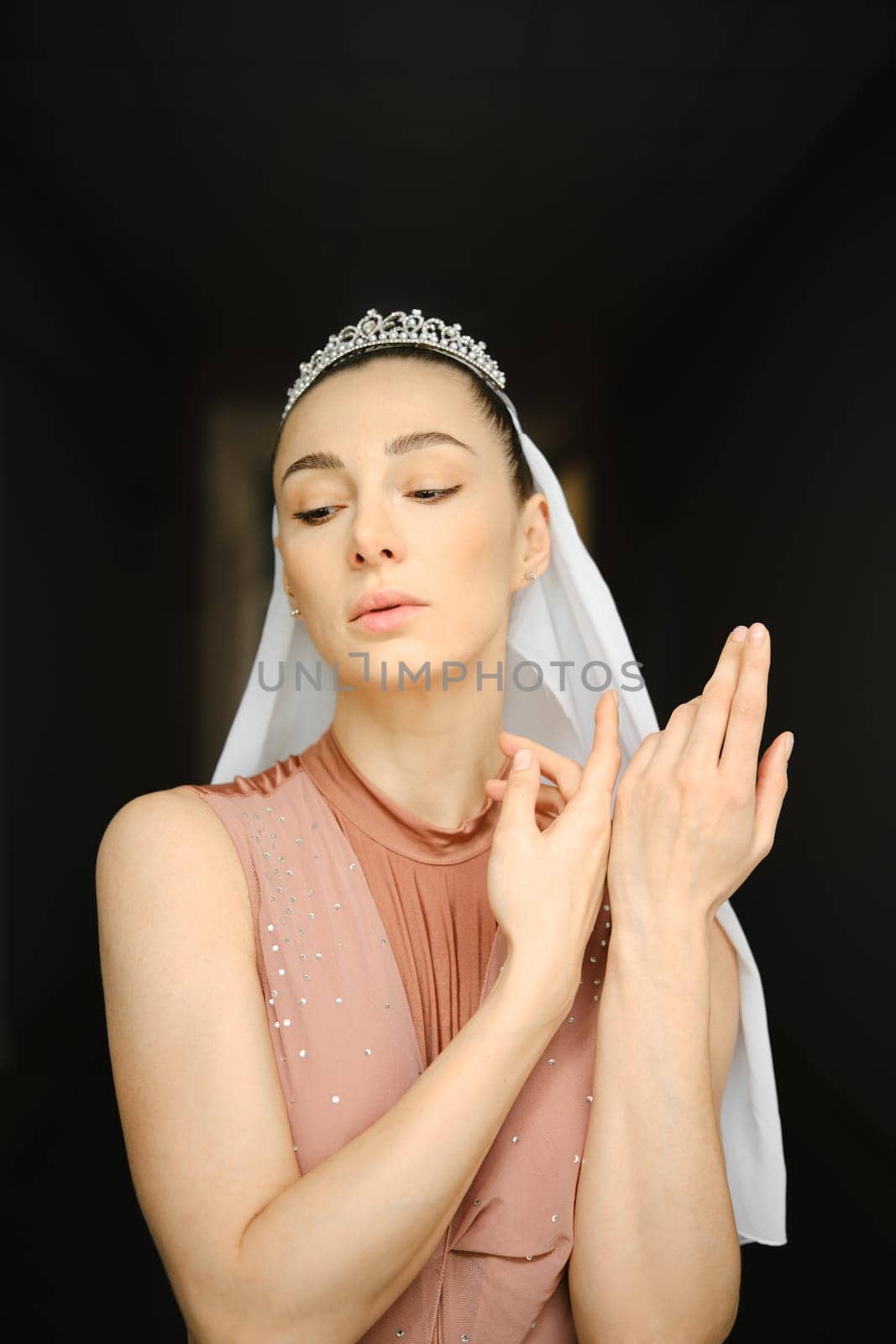 Portrait of ballerina with closed eyes in beige dress
