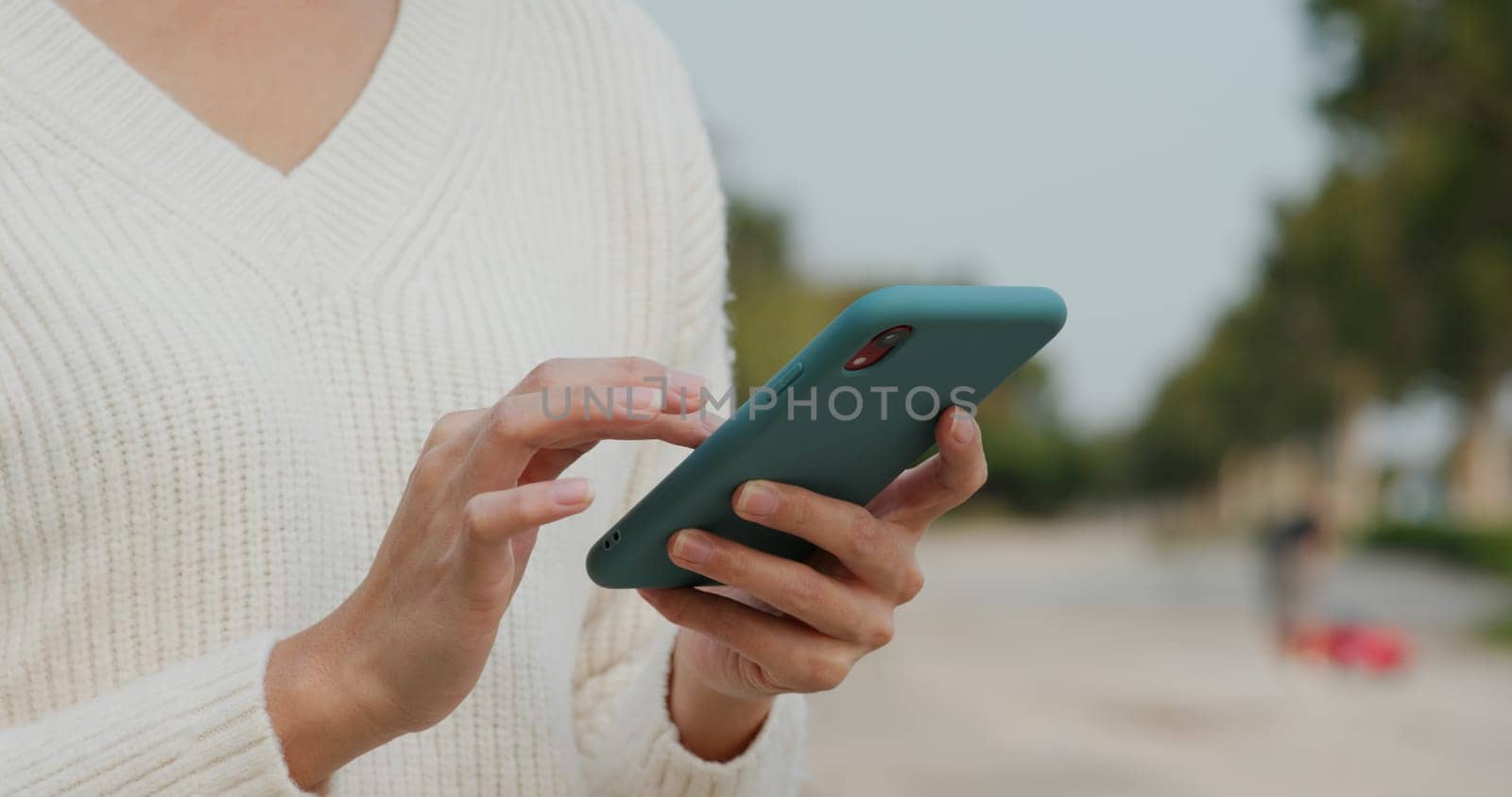 Woman uses mobile phone on street