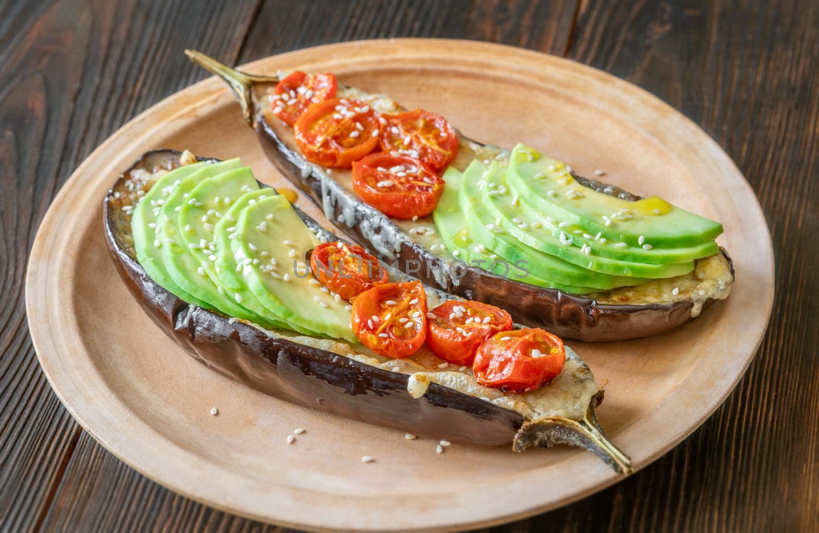 Baked eggplant with cheese, avocado and tomatoes