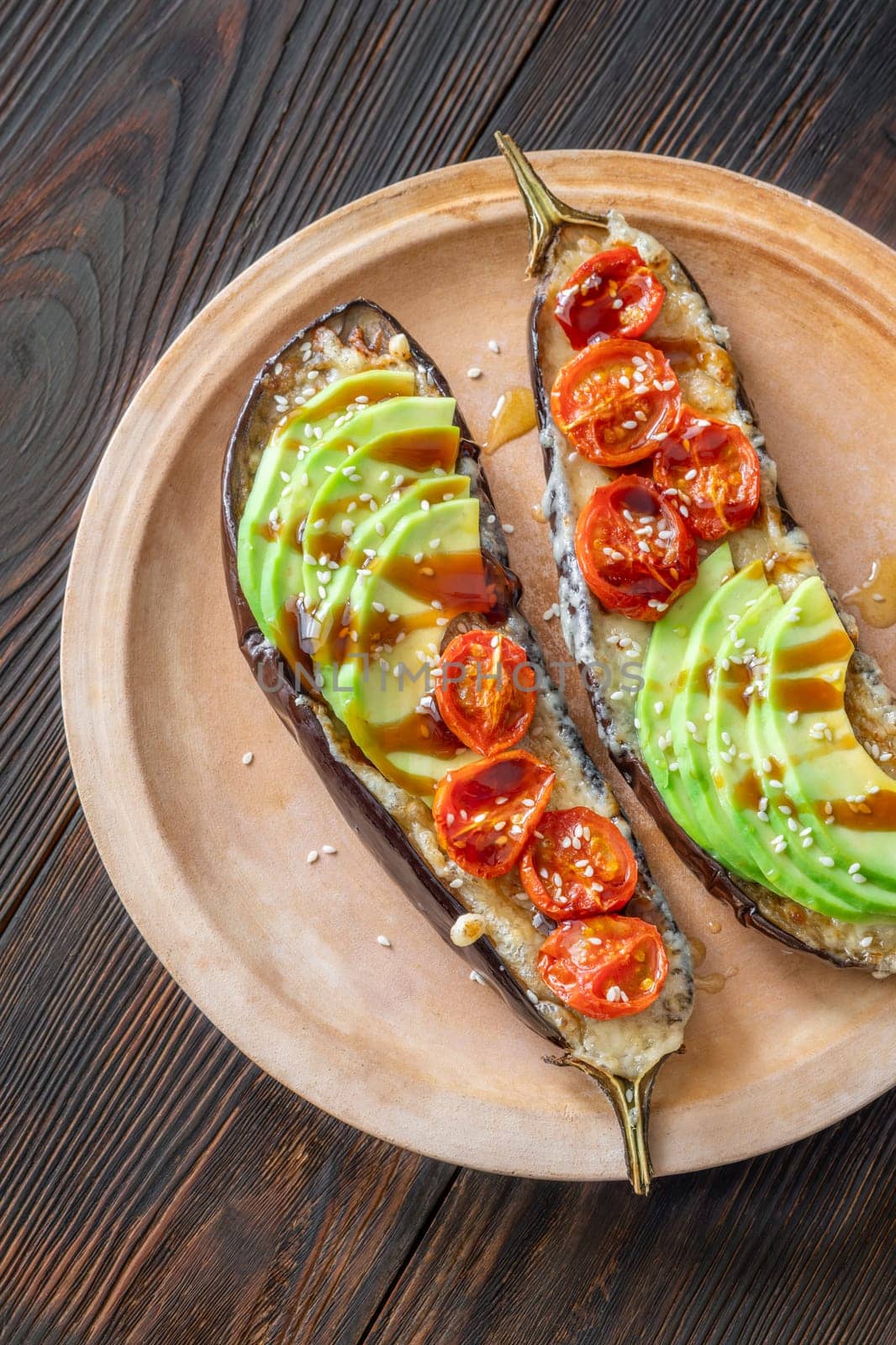 Baked eggplant with cheese, avocado and tomatoes