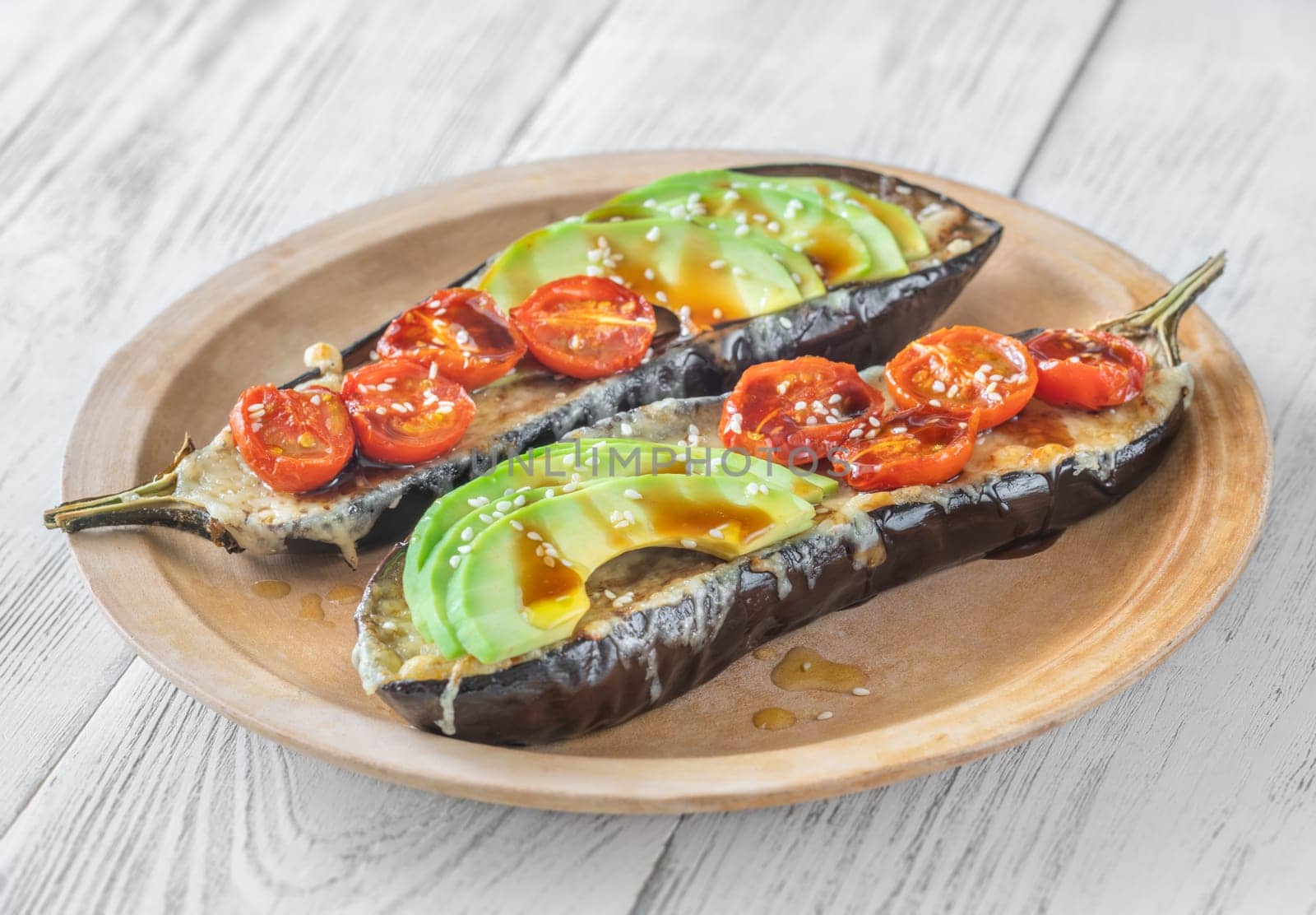 Baked eggplant with cheese, avocado and tomatoes
