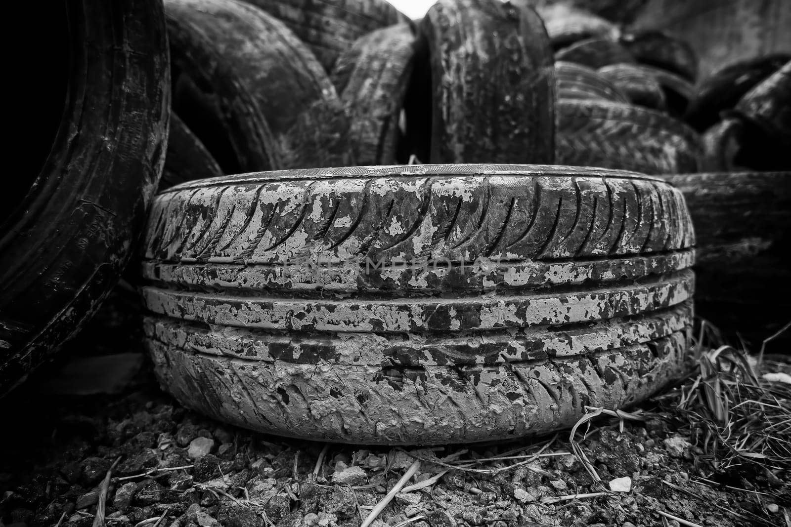Detail of old damaged and worn car tire, recycling