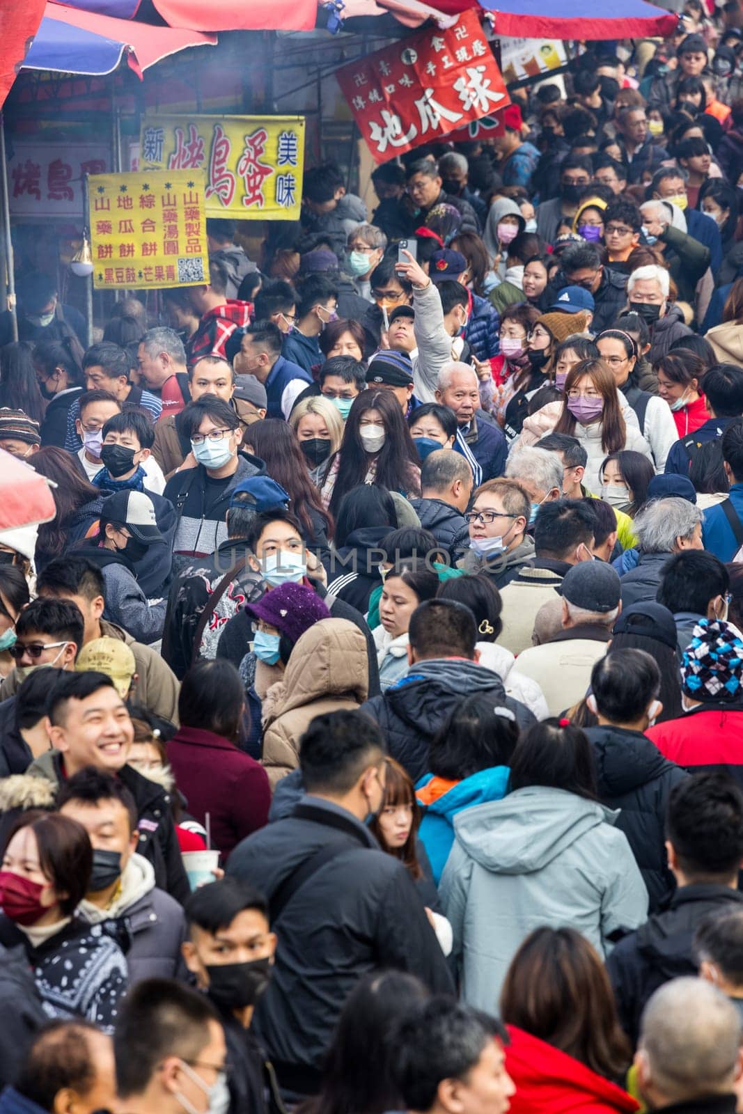 New Taipei, Taiwan 10 February 2024: Crowded of people cross the street market