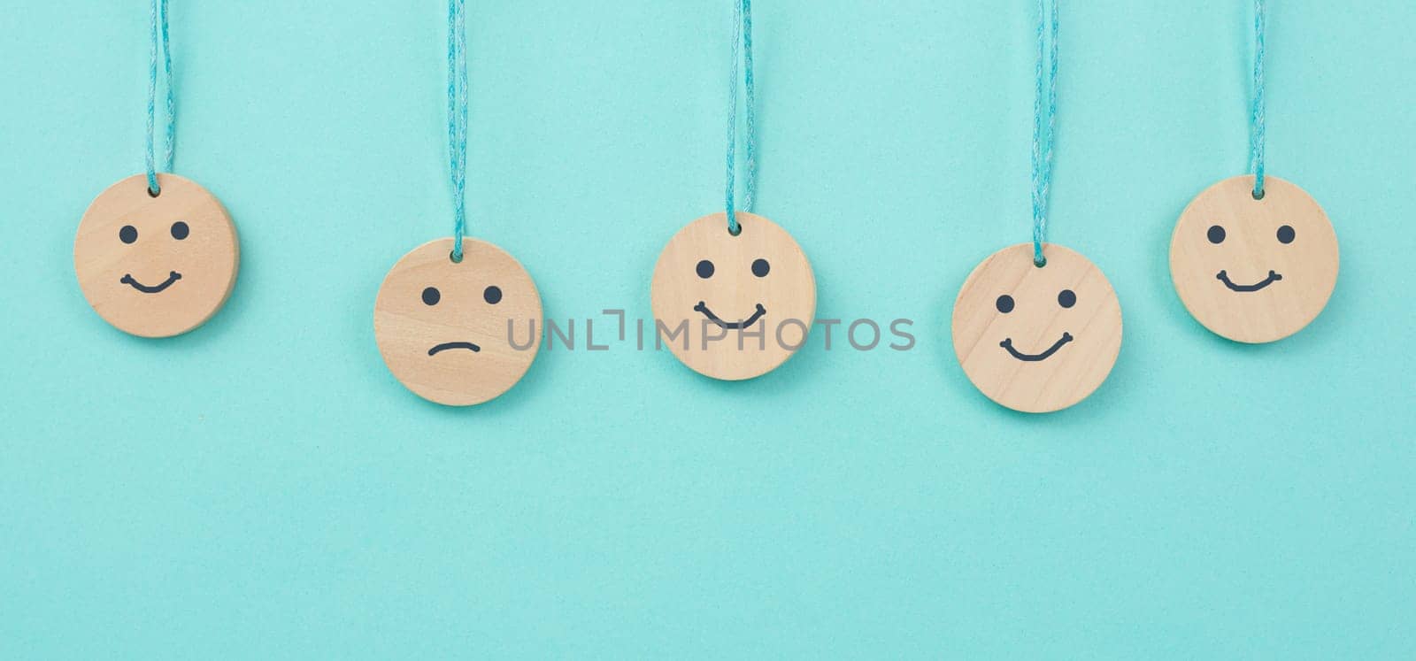 Happy smiling face spread happiness to sad faces, newton cradle concept, mental health and attitude, positive and negative mind, influence emotion, support and depression, pendulum balls