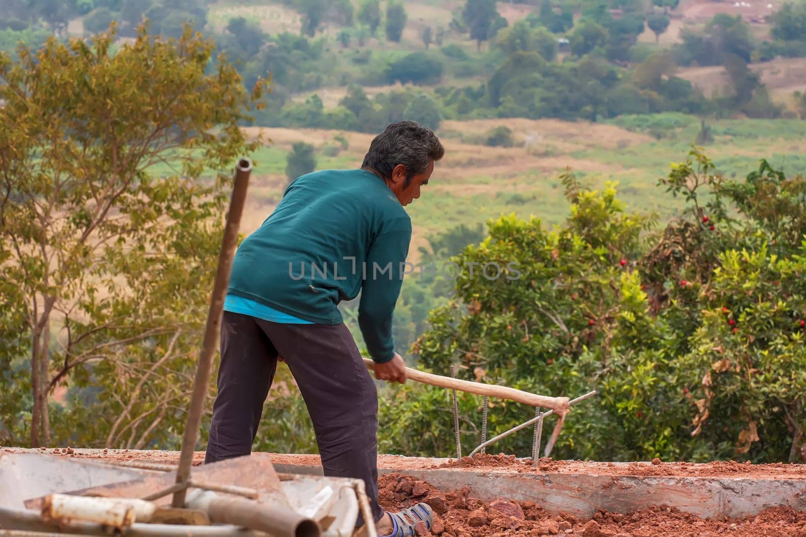 Construction worker are digging the ground to make walkways and walls.