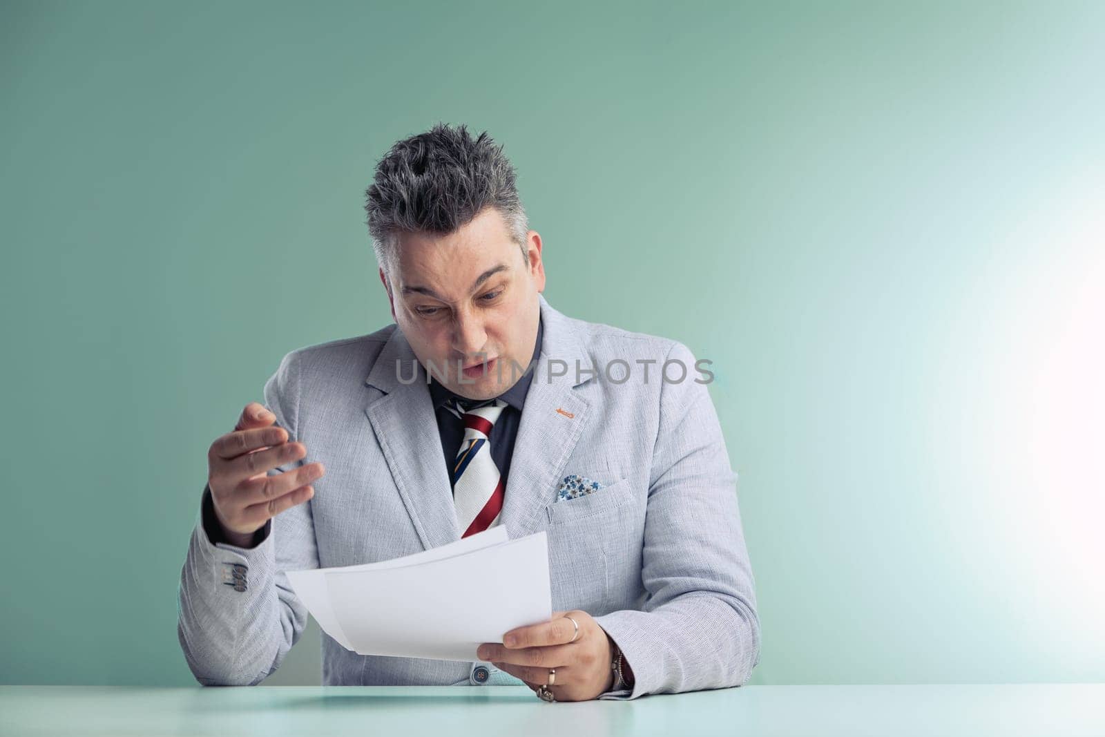 Middle-aged conspiracy theorist anchorman scrutinizes papers, his expression showing deep concern and disbelief