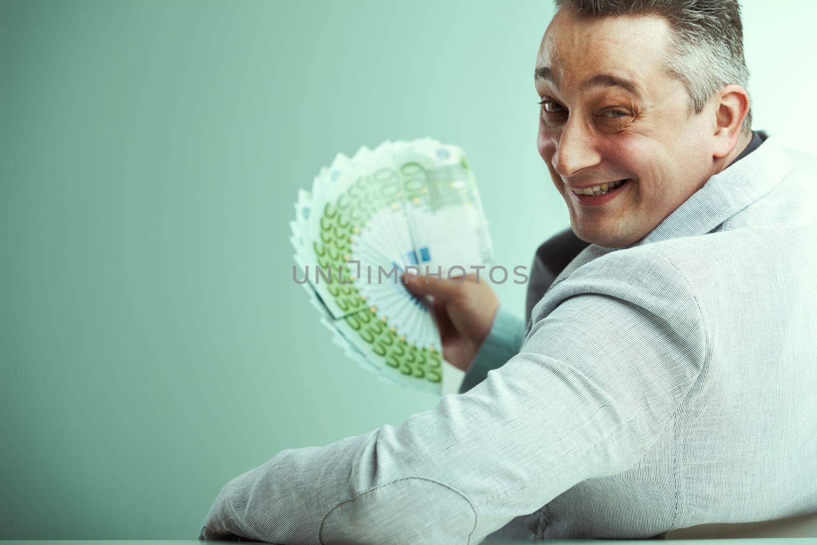 Fraudulent figure grinning widely as he displays a large amount of cash, symbolizing false promises of wealth