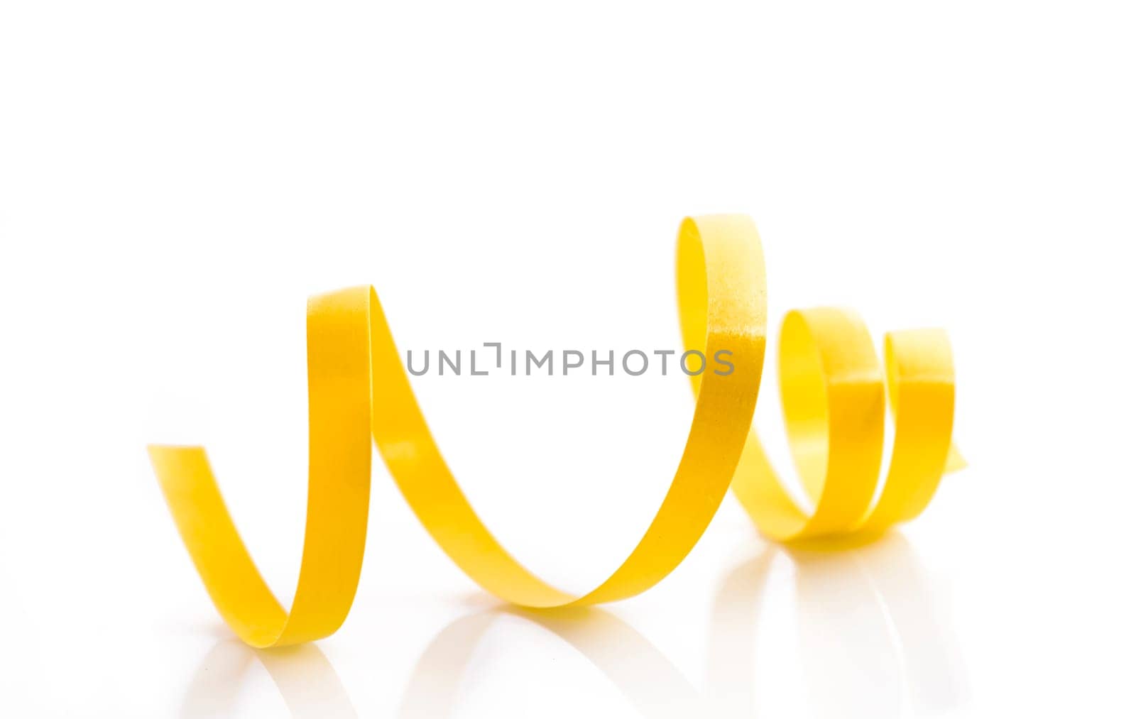 Decorative christmas ribbon isolated on white background. Holiday golden curly tape roll for birthday, wedding, new year or xmas gift wrap decor.