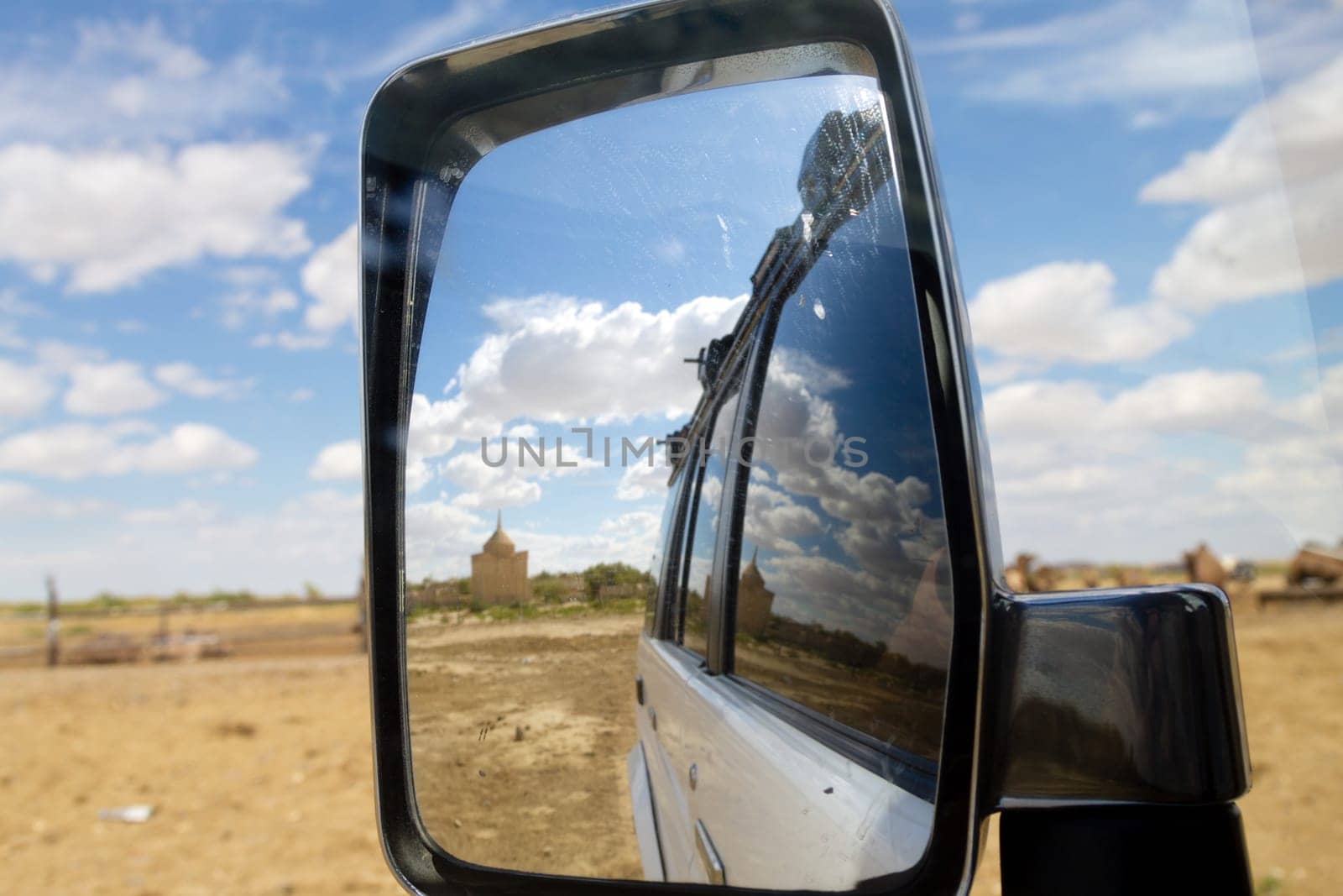 Nurbergen Kylyshev Mausoleum reflected in vehicle mirror, Mangystau region, Kazakhstan