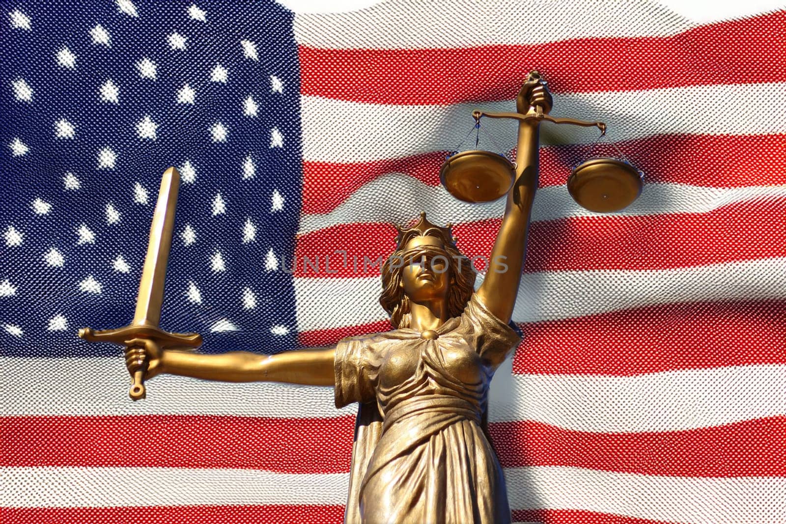 The Statue of Justice, Goddess of Justice in front of the USA flag.