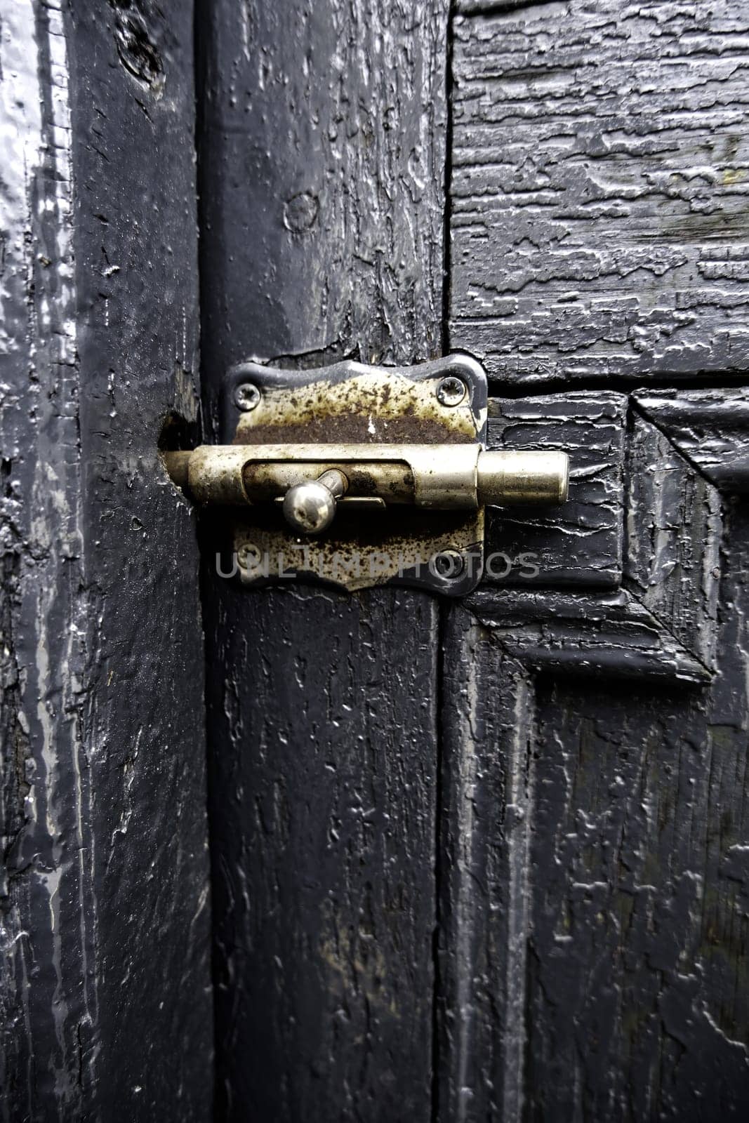 Detail of security lock on an old wooden door