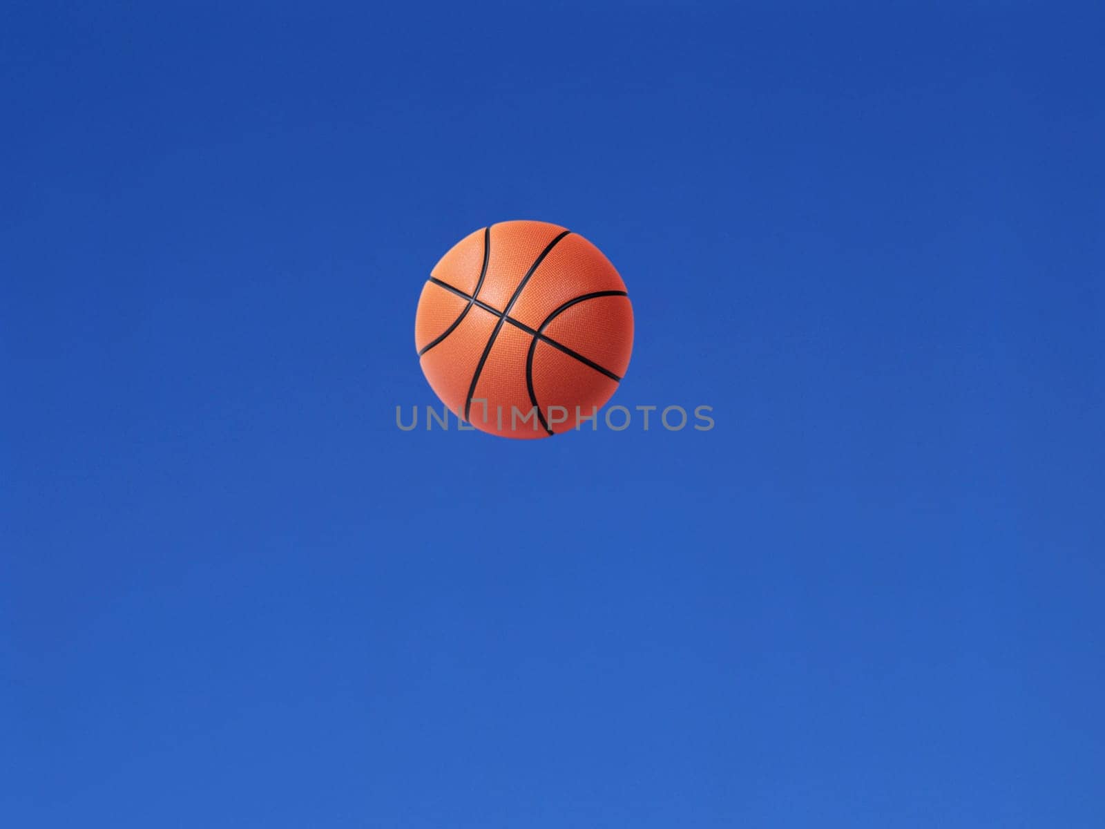 A basketball shot in the air with blue sky background