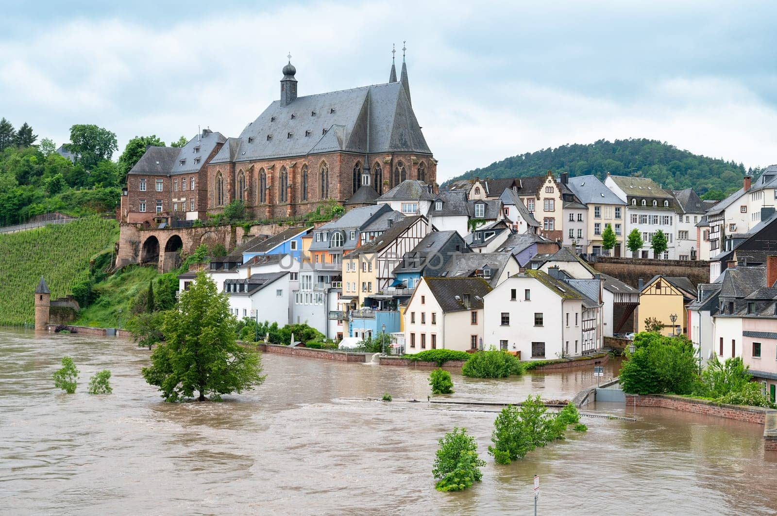 Flood of the river Saar, Saarburg in Saarland, Germany, flooded trees and paths, high water level, climate change