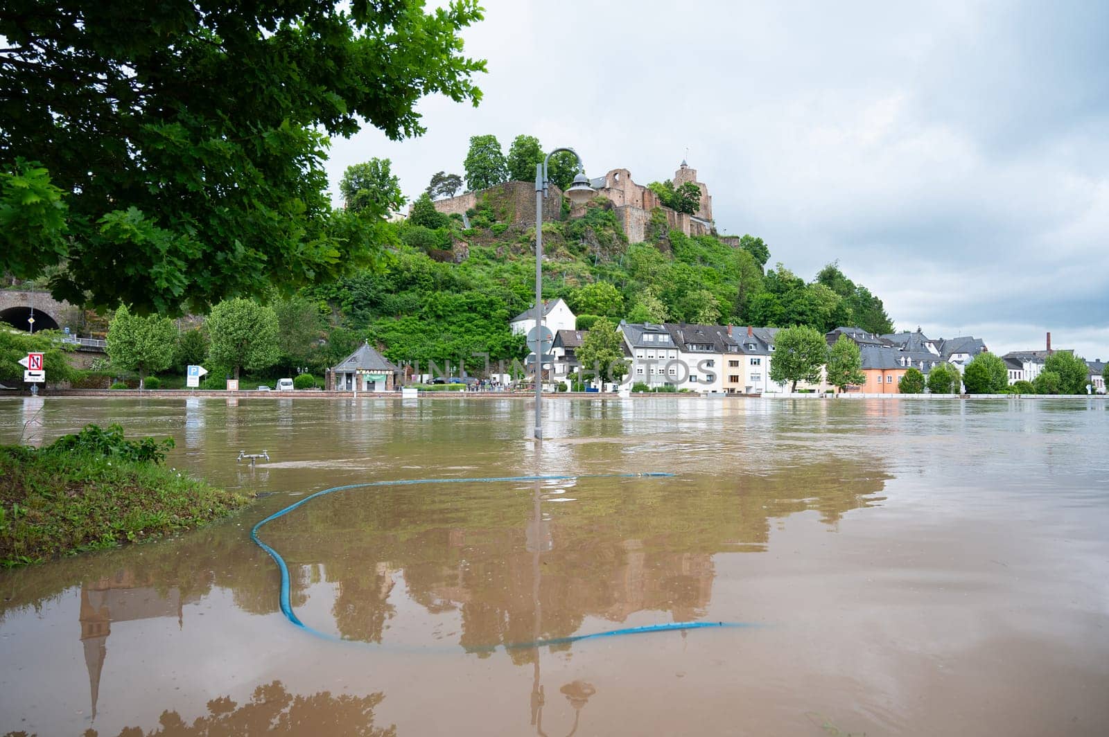 Flood of the river Saar, Saarburg in Saarland, Germany, flooded trees and paths, high water level, climate change