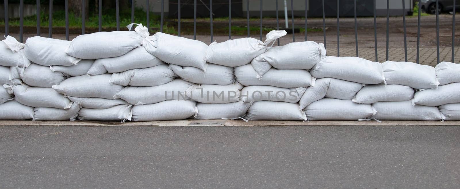 Sandbags for flood defense, river Moselle Trier in Rhineland Palatinate, flooded trees and paths, high water level, climate change