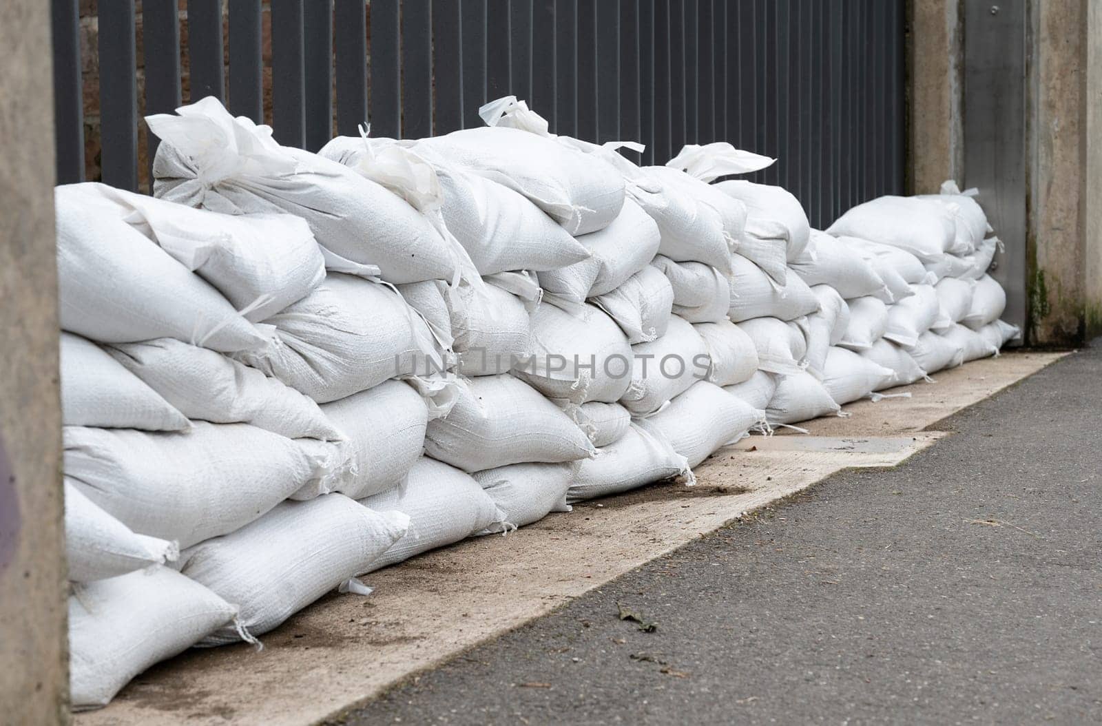 Sandbags for flood defense, river Moselle Trier in Rhineland Palatinate, flooded trees and paths, high water level, climate change