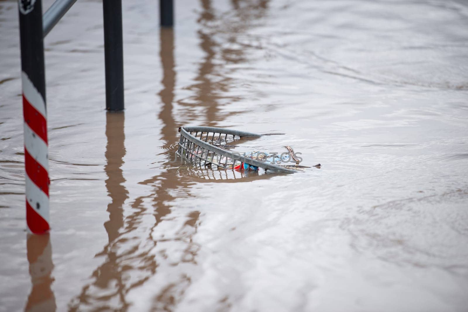 Flood of the river Moselle, Trier in Rhineland Palatinate, flooded garbage bin, high water level, dirt washed up on the shore