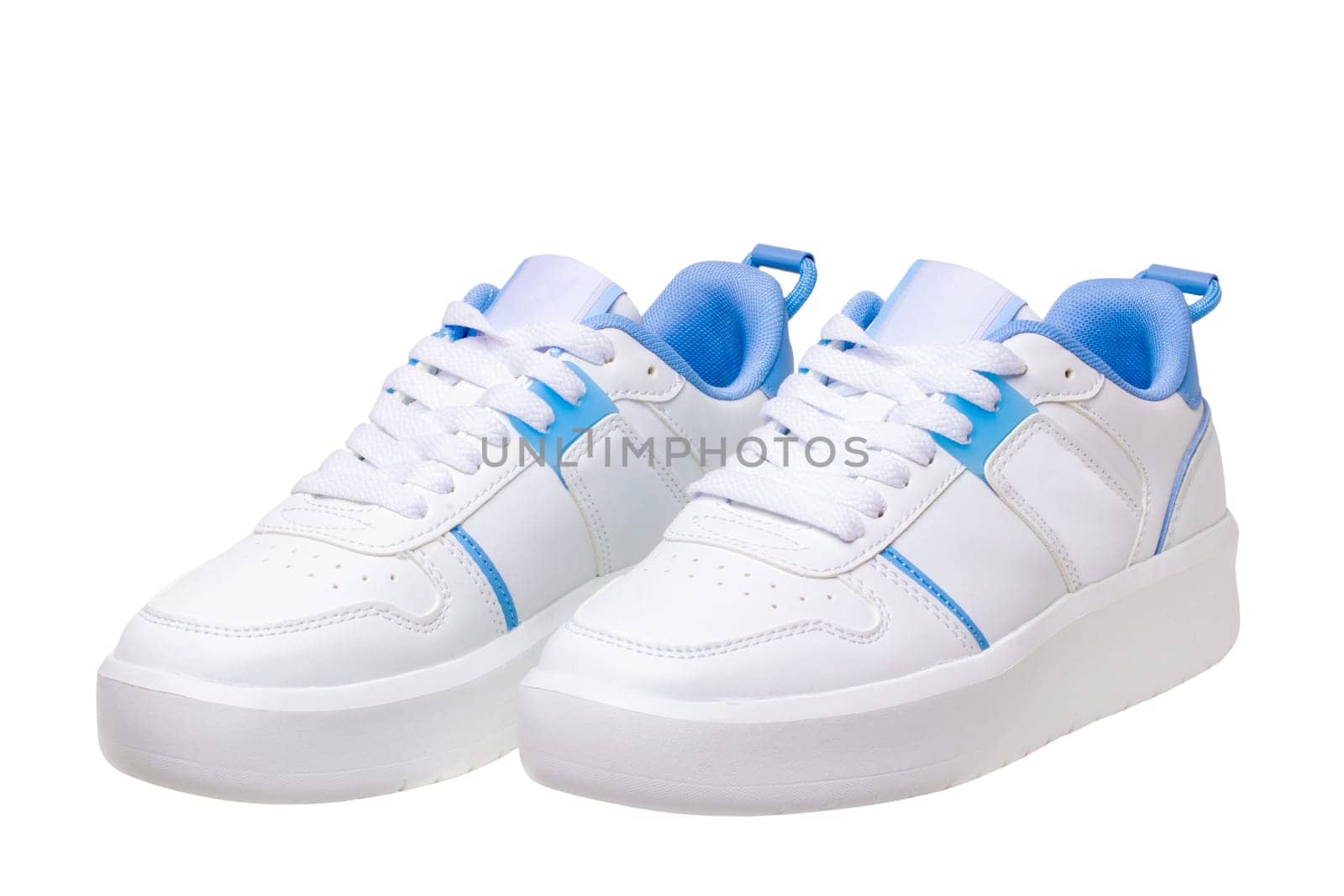 White sneaker isolated. Close-up of a pair white elegant stylish female leather high-heeled sport shoes isolated. Clipping path. Womens shoe fashion. Modern design footwear for workout.