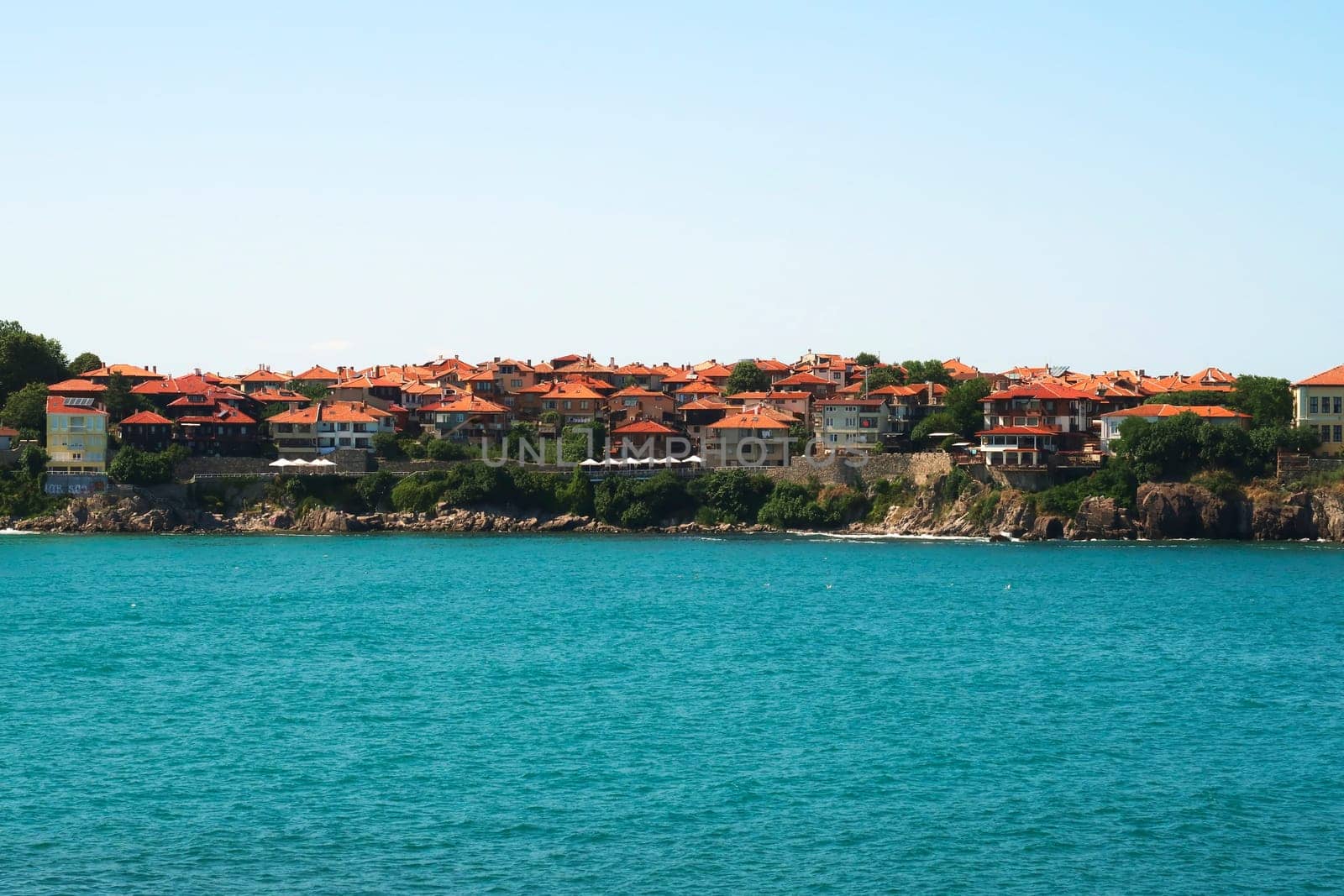 View onto the old town of Sozopol, Sosopol with the intense turquoise blue water of the black sea in the foreground, Bulgaria 2022